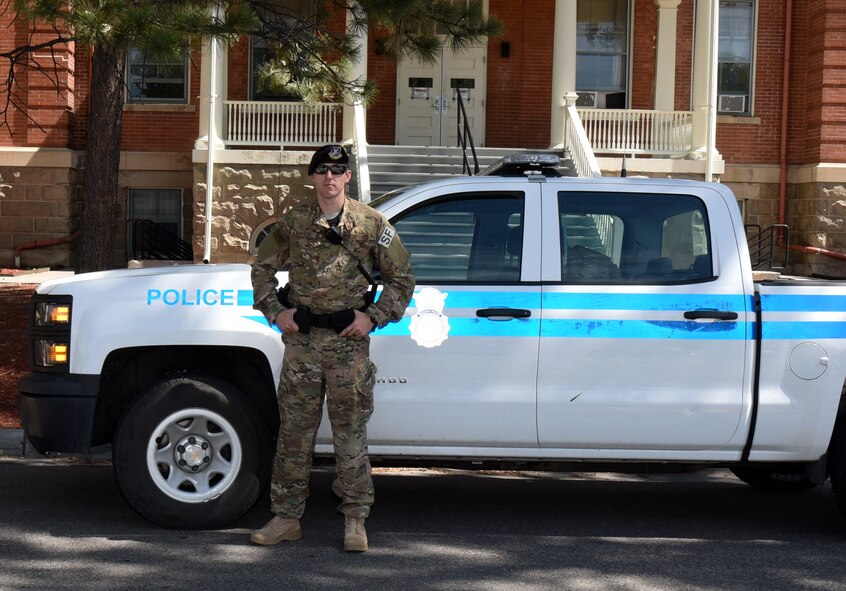 Staff Sgt. Charles Watson, 90th Security Forces Squadron patrolman, poses in front of his patrol vehicle at F.E. Warren Air Force Base, Wyo., July 14, 2017. 90th SFS defenders ensure the security of the installation through law enforcement. (U.S. Air Force photo by Airman 1st Class Breanna Carter)