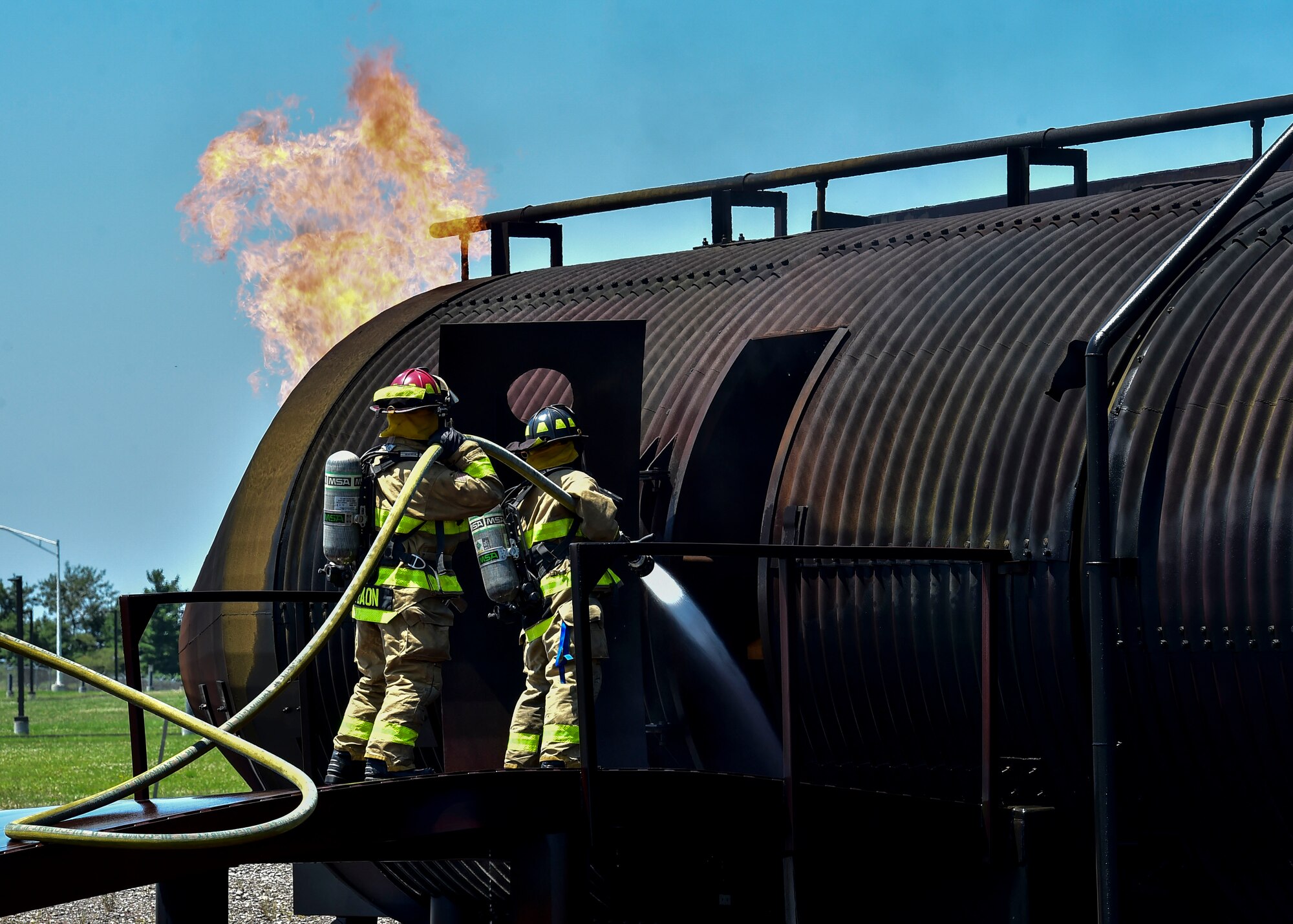 Specialist Leah Thurston leads teammate Staff Sgt. Chad Baon, firefighters from the 5694th Engineer Detachment from the Army National Guard stationed in Mansfield, Ohio, into a simulated C-130 fire during their annual training July 18, 2017, here. The 5694th are at YARS for one week while completing their annual training. (U.S. Air Force Photo/Senior Airman Jeffrey Grossi)