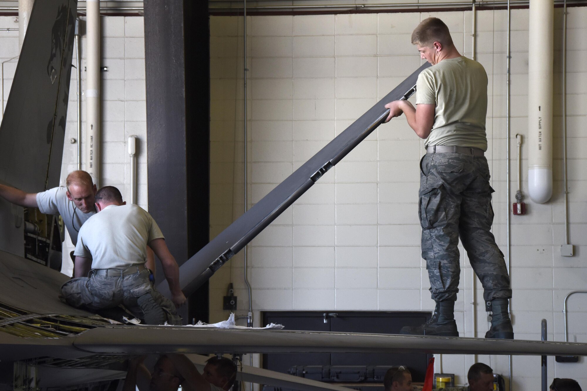 114th Aircraft Maintenance Squadron phase inspection element Armen reinstalled a flap from an F-16 wing during the Fix Phase of a phase maintenance inspection at Joe Foss Field, July 8, 2017.  Each aircraft is required to go through a phase inspection every 400 flight hours to ensure all systems are functioning with in Air Force regulations.  (U.S. Air National Guard photo by Master Sgt. Christopher Stewart/Released)