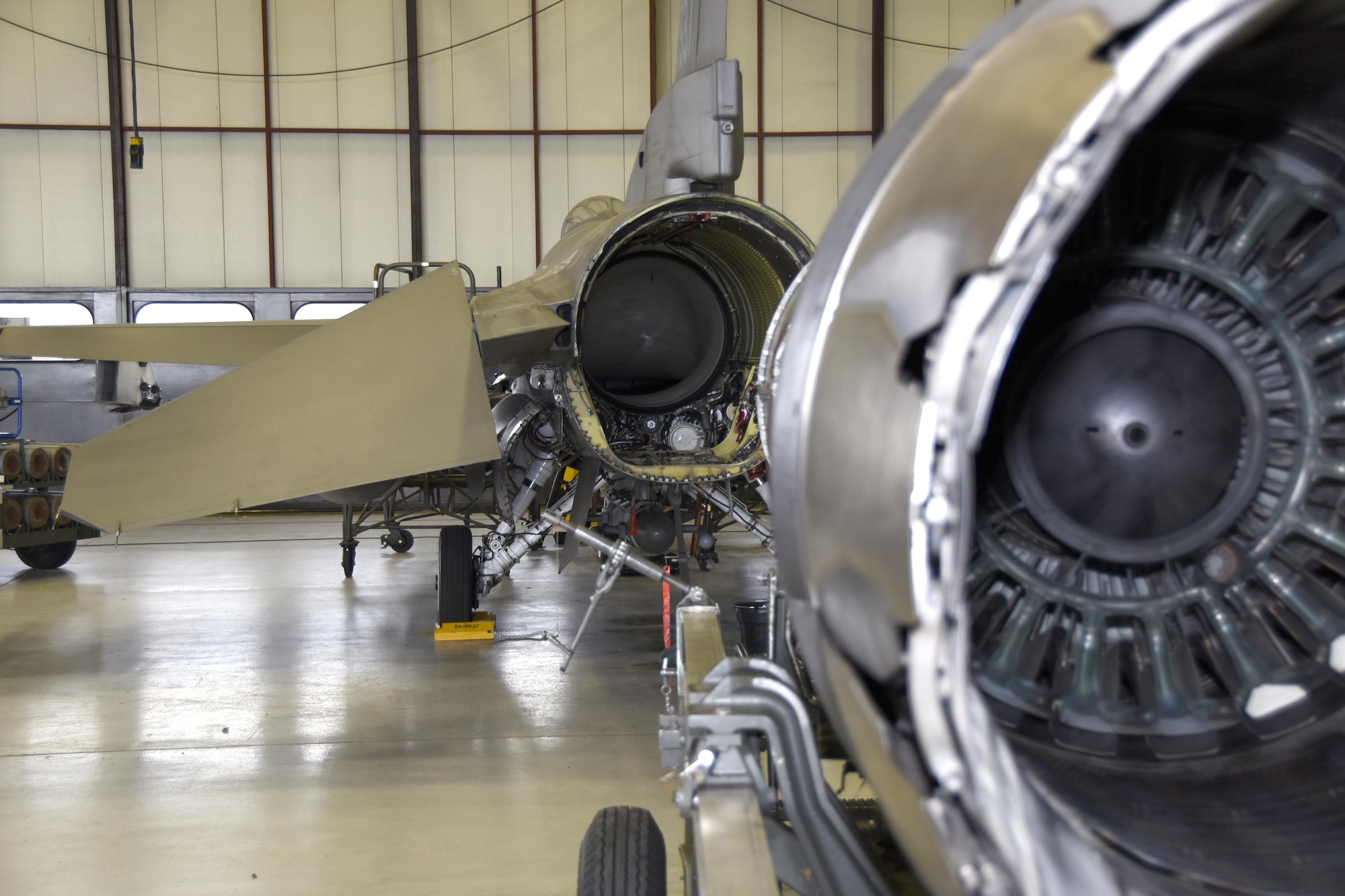 114th Aircraft Maintenance Squadron engine shop Airmen Line up an engine to reinstall into the rear of an F-16 at Joe Foss Field July 18 2017.  Each aircraft is required to go through a phase inspection every 400 flight hours to ensure all systems are functioning with in Air Force regulations.  (U.S. Air National Guard photo by Master Sgt. Christopher Stewart/Released)