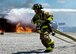 An Army firefighter of the 5694th Engineer Detachment from the Army National Guard stationed in Mansfield, Ohio, rushes to unravel a fire hose so he may combat a blaze during an airport rescue firefighting exercise July 18, 2017,  here. The YARS burn pit provides real time firefighting training experiences for not only YARS but for its neighbors too. (U.S. Air Force Photo/Senior Airman Jeffrey Grossi)