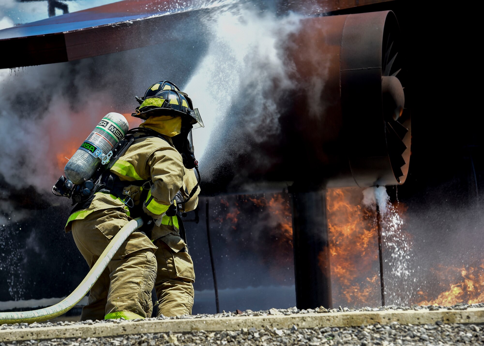 Army firefighters of the 5694th Engineer Detachment from the Army National Guard stationed in Mansfield, Ohio, stand their ground while fighting back a simulated C-130 fire July 18, 2017, here. The 5694th is at YARS for one week while completing their annual training. (U.S. Air Force Photo/Senior Airman Jeffrey Grossi)