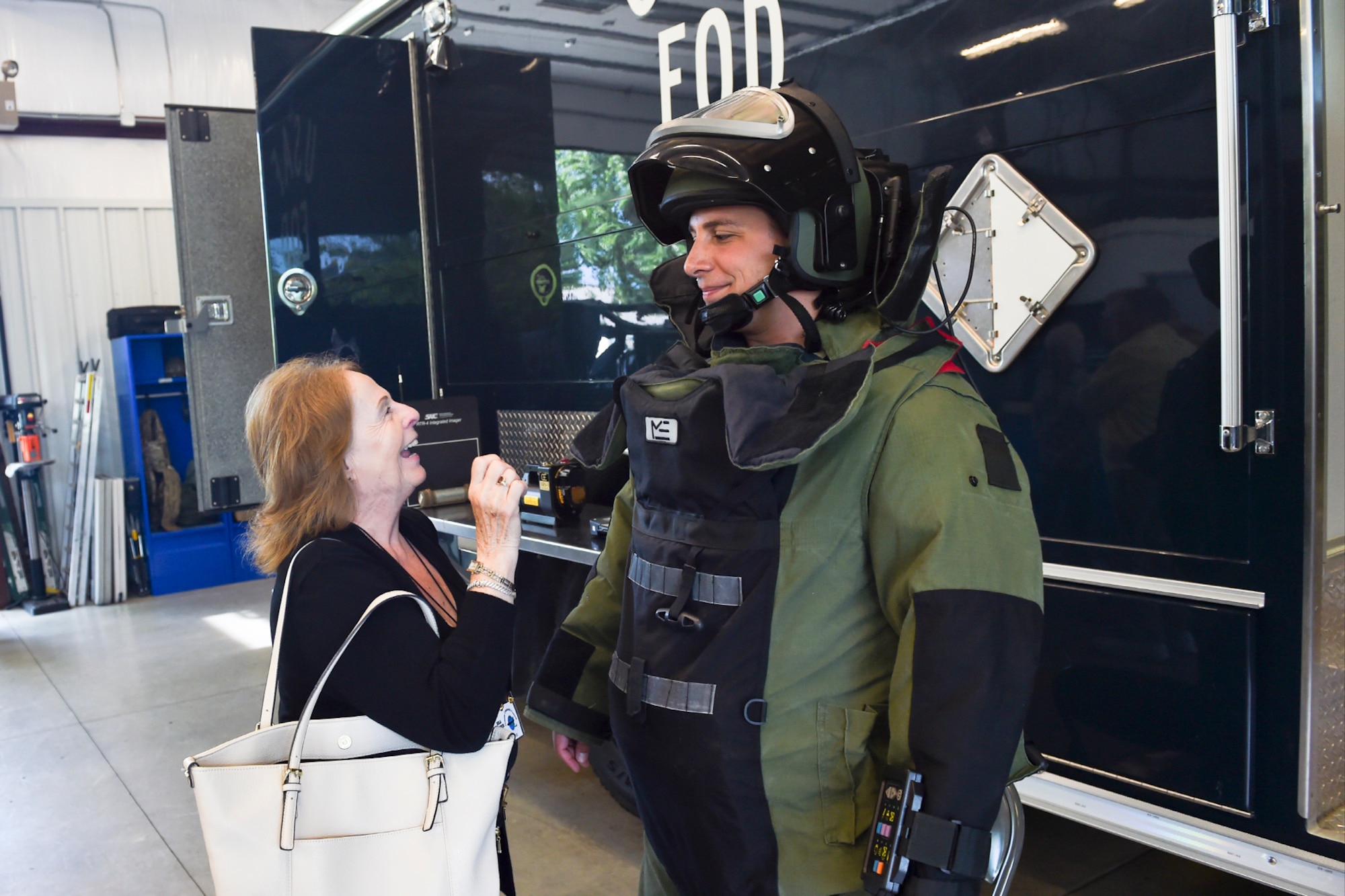Senior Airman Rogerito Miravetedisantis, 434th Civil Engineer Squadron Explosive Ordinance Disposal Journeyman, shows Rosemary Job, Grissom Community Council member, his bomb suit at Grissom Air Reserve Base, Ind., July 7, 2017. The suit is used for protection during EOD missions. (U.S. Air Force photo/Senior Airman Cali Wetli)