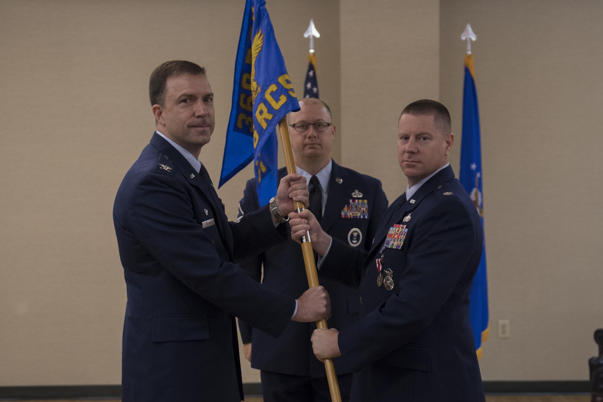 Col. Bradly Oliver, 369th Recruiting Group commander, receives the guidon from Lt. Col. David Lederer, left, outgoing 336th Recruiting Squadron commander, as he relinquishes command, July 19, 2017, at Moody Air Force Base, Ga. The 336th RCS is a tenant unit at Moody Air Force Base and covers 75,489 square miles including areas in Georgia, South Carolina, Florida and Alabama. Its mission is to inspire, engage and recruit the brightest, most competitive and diverse men and women for service in The U.S. Air Force. (U.S. Air Force photo by Airman 1st Class Daniel Snider)