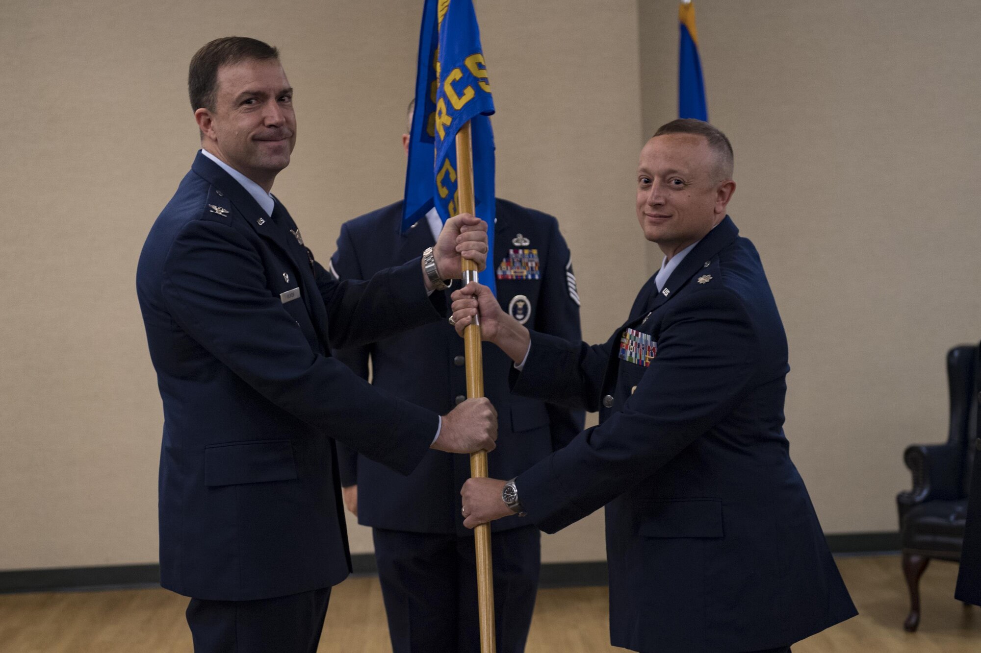 Col. Bradly Oliver, 369th Recruiting Group commander, passes the guidon to Lt. Col. Erwin Waibel, 336 Recruiting Squadron commander, signifying his assumption of command, July 19, 2017, at Moody Air Force Base, Ga. The 336th RCS is a tenant unit at Moody Air Force Base and covers 75,489 square miles including areas in Georgia, South Carolina, Florida and Alabama. Its mission is to inspire, engage and recruit the brightest, most competitive and diverse men and women for service in The U.S. Air Force. (U.S. Air Force photo by Airman 1st Class Daniel Snider)