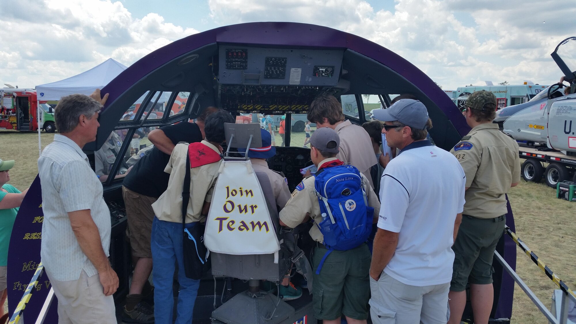 Senior Master Sgt. William rudgers and Master Sgt. James Courneya help boy Scouts earn their aviation merit badges at the Wings of the North Airshow at Flying Cloud airport July 15-16. The scouts learned to identify and interpret cockpit instruments from the C-130 flight deck on display at the airshow. (Air Force Photo/Master Sgt. James Courneya)