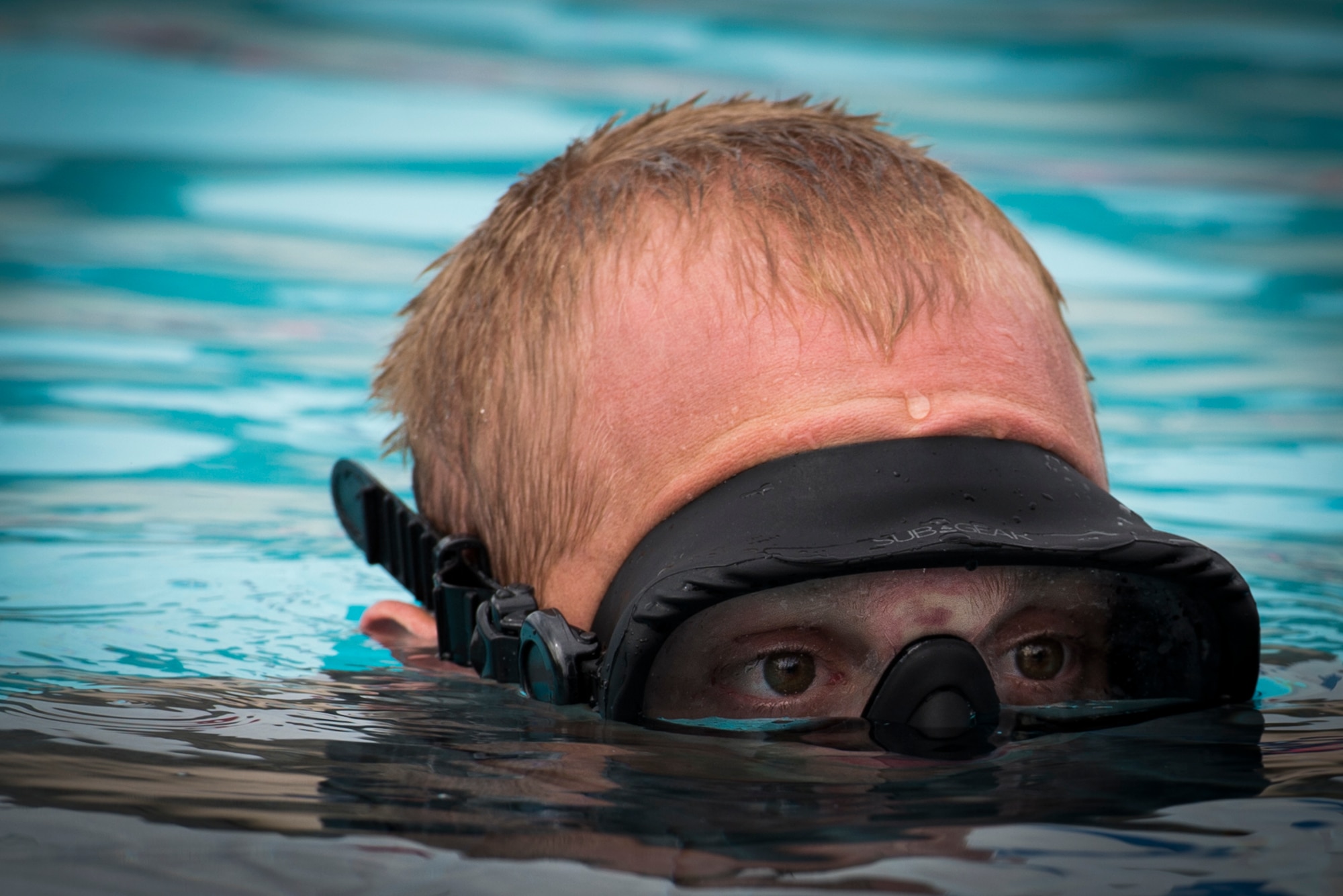 Senior Airman Heath Jolley, a survival, evasion, resistance and escape specialist with the 1st Special Operations Support Squadron, supervises a rotary wing water survival training from underwater at Hurlburt Field, Fla., July 18, 2017. Three SERE specialists supervised more than 10 aircrew members performing emergency exit procedures while submerged to ensure the aircrew is proficient if ever faced with a real-world incident. (U.S. Air Force photo by Airman 1st Class Joseph Pick)