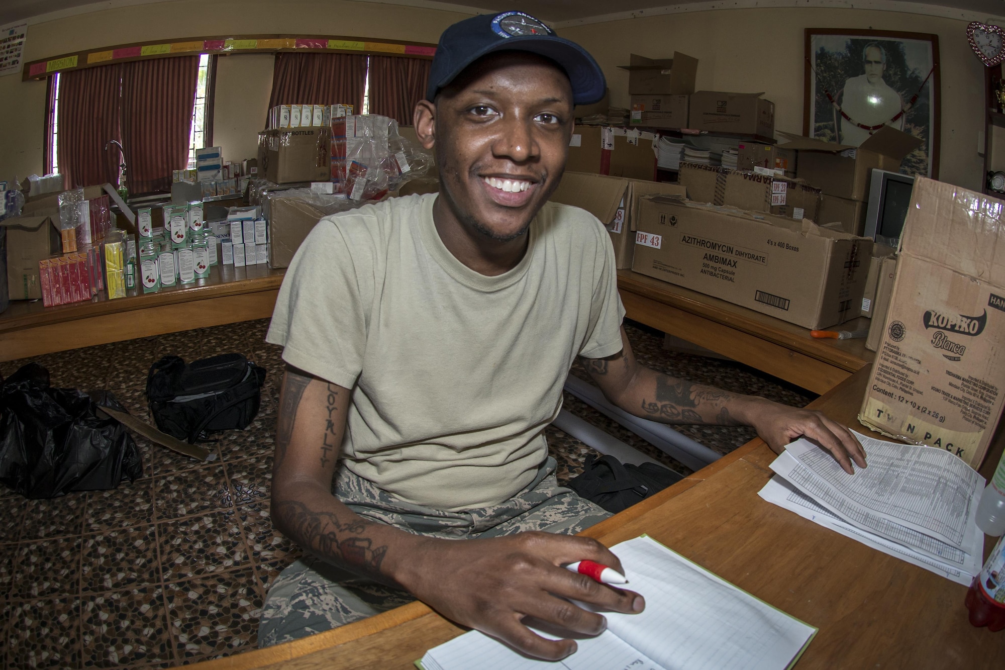 U.S. Air Force Staff Sgt. Marcus Hollins, a pharmacy technician with the 35th Medical Support Squadron at Misawa Air Base, Japan, smiles for the camera as he reviews pharmaceutical inventories during Pacific Angel 17-3 at the Tagitagi Sangam School and Kindergarten in Tavua, Fiji, July 17, 2017. The pharmacy provides all the medications participating health care professionals require to treat patients who come to the health services site seeking care.  PACANGEL 17-3 builds partnerships between the US, Fiji, and several regional nations by conducting multilateral humanitarian assistance and civil military operations, promoting regional military-civilian-nongovernmental organization cooperation and interoperability. (U.S. Air Force photo by Tech. Sgt. Benjamin W. Stratton)
