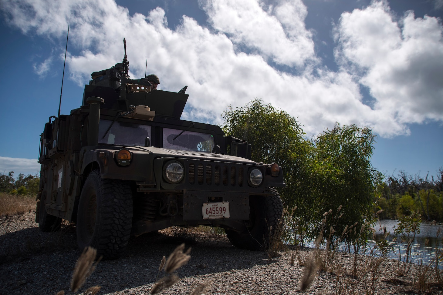 170713-N-WF272-407 TOWNSHEND ISLAND, Australia (July 13, 2017) Marines, assigned to Battalion Landing Team, 3rd Battalion, 5th Marines, part of the 31st Marine Expeditionary Unit (MEU), secure a position in a high-mobility multipurpose wheeled vehicle (HMMWV) as part of a large-scale amphibious assault during Talisman Saber 17. The 31st MEU is working in tandem with Australian counterparts to train together in the framework of stability operations. (U.S. Navy video by Mass Communication Specialist 2nd Class Diana Quinlan/Released)