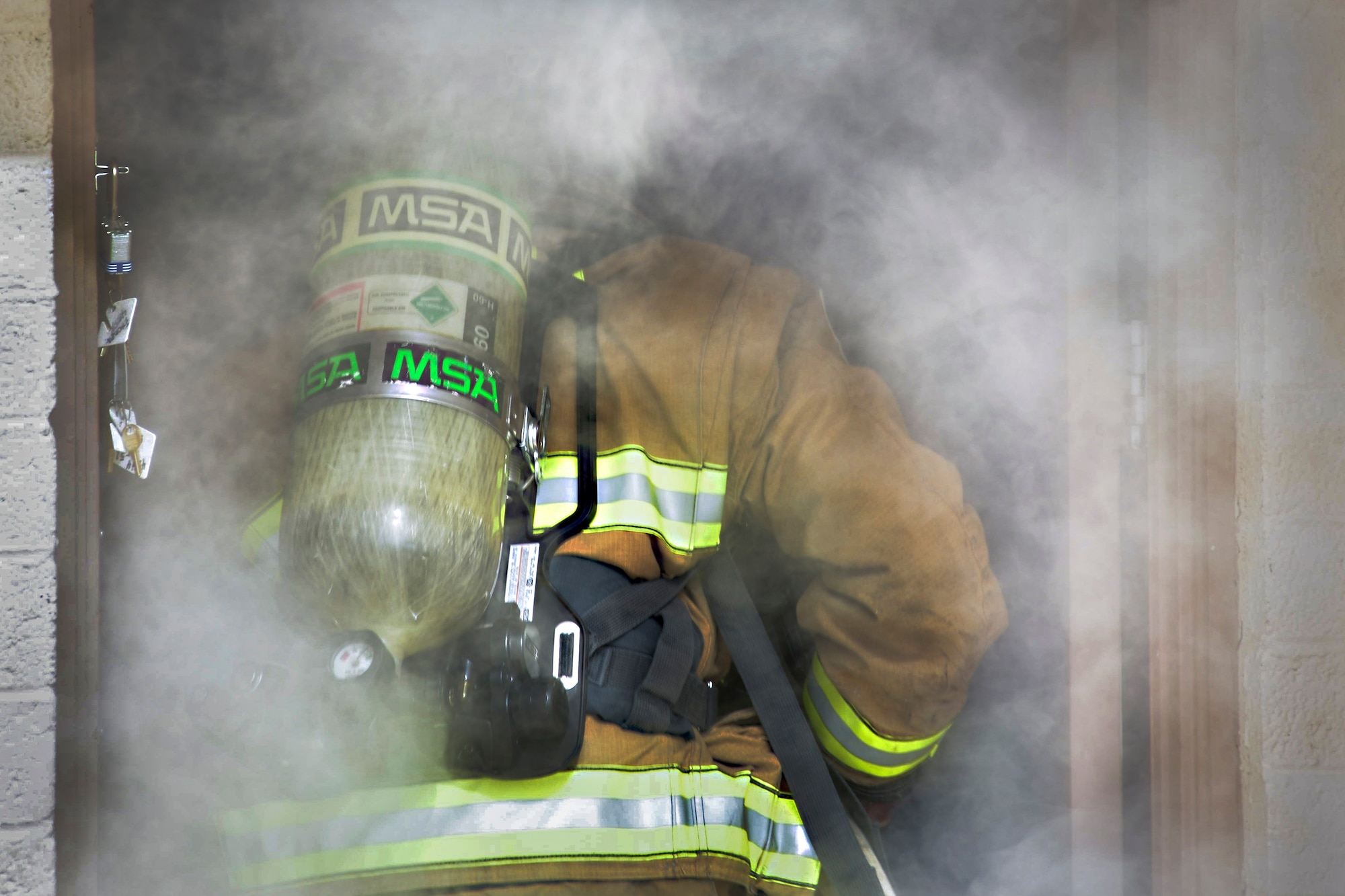 Staff Sgt. Blaine Erway, 99th Civil Engineer Squadron firefighter crew chief, prepares to enter a simulated house fire during Red Flag 17-3 at Nellis Air Force Base, Nev., July 18, 2017. With Red Flag 17-3 in full effect, 99th CES firefighters are in the middle of their busiest time of year. (U.S. Air Force photo by Airman 1st Class Andrew D. Sarver/Released)