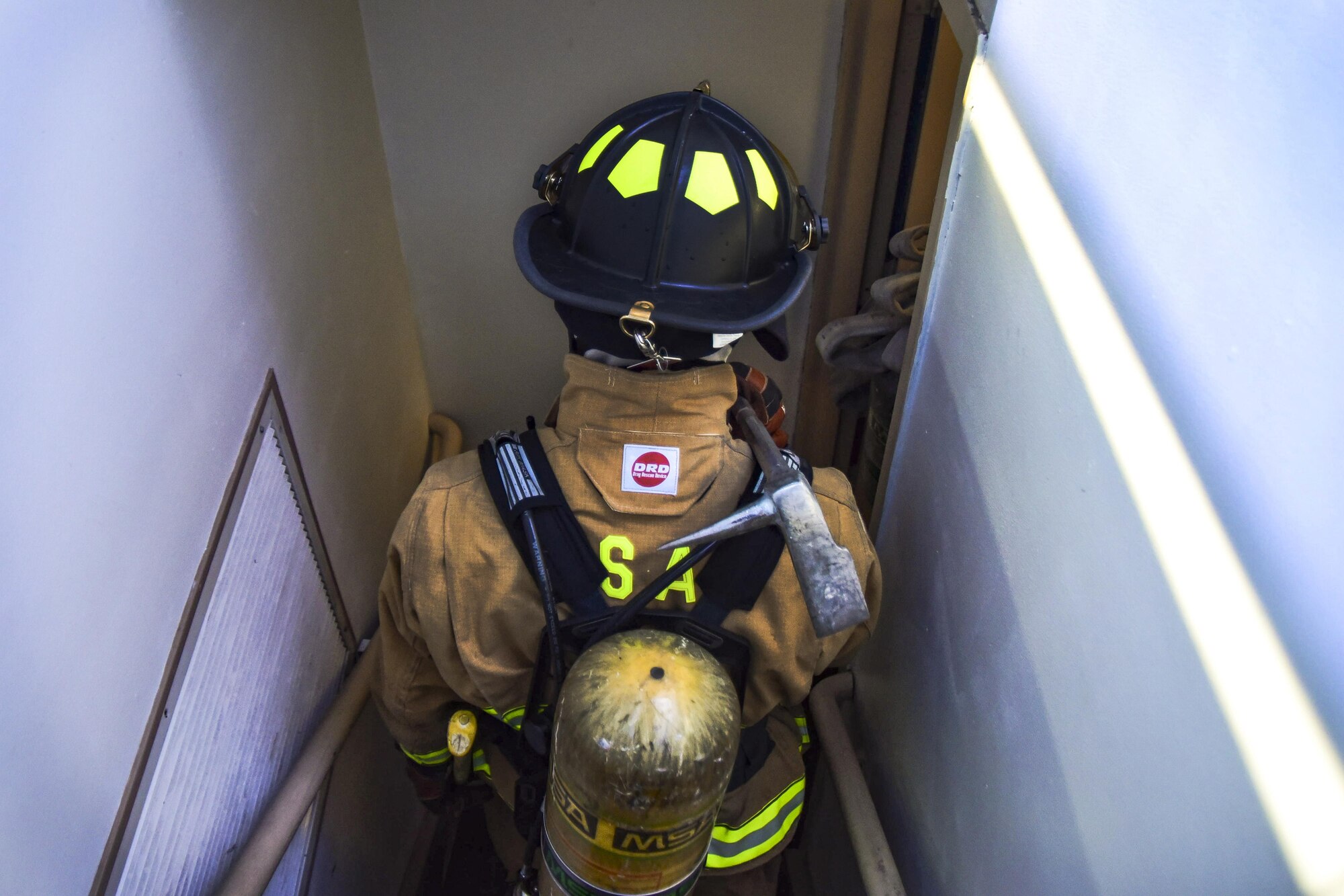 Airman 1st Class Brian Velten, 99th Civil Engineer Squadron firefighter, descends the air traffic control stairwell during Red Flag 17-3 at Nellis Air Force Base, Nev., July 18, 2017. The team raced to the top of the tower to practice evacuation procedures during an electrical fire or medical emergency. (U.S. Air Force photo by Airman 1st Class Andrew D. Sarver/Released)