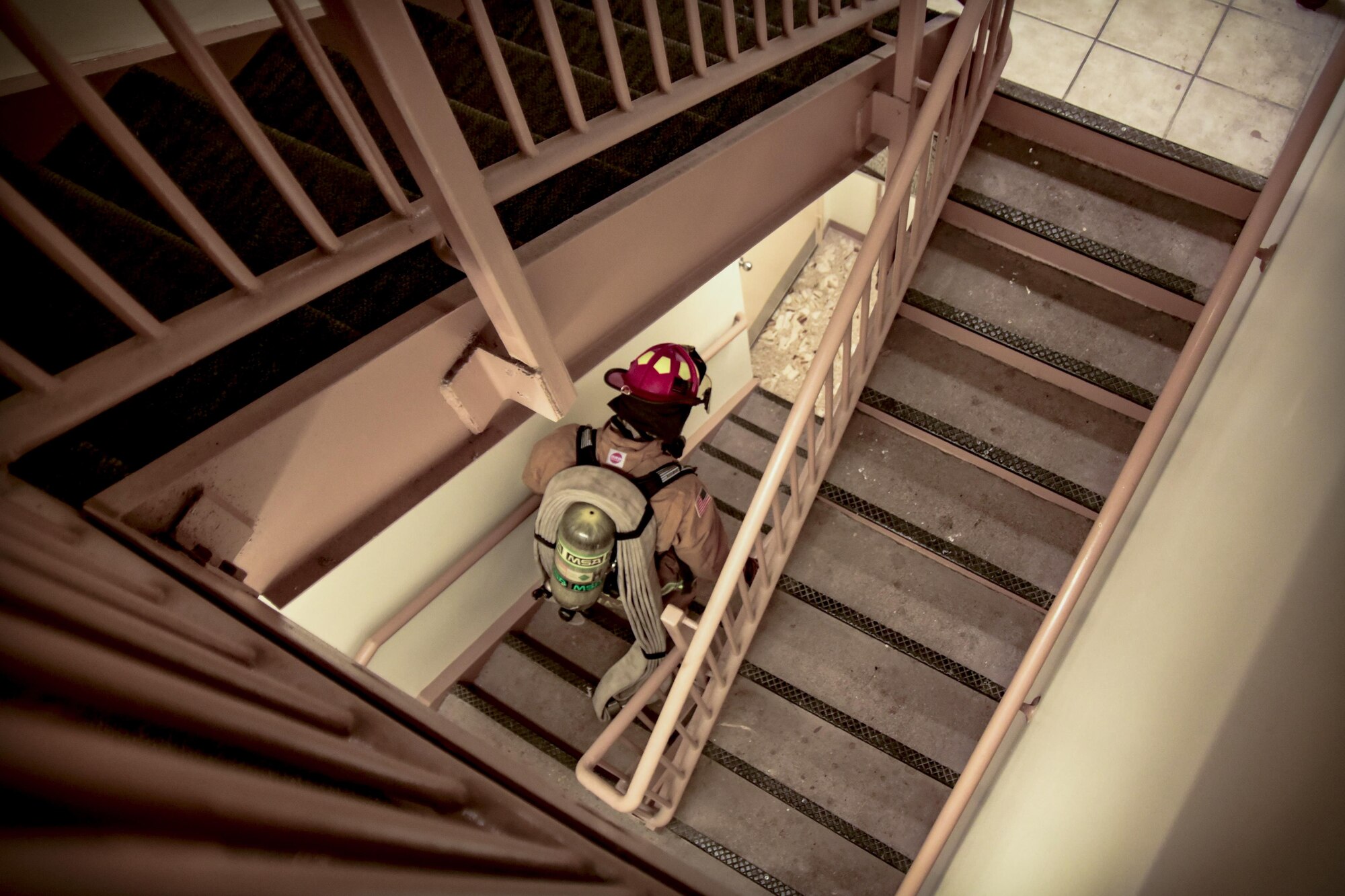Staff Sgt. Blaine Erway, 99th Civil Engineer Squadron firefighter crew chief, descends the air traffic control stairwell during Red Flag 17-3 at Nellis Air Force Base, Nev. July 18, 2017. The team ascended more than 10 flights of stairs with more than 130 pounds of gear in less than two minutes to practice emergency response capabilities at the top of the air traffic control tower. (U.S. Air Force photo by Airman 1st Class Andrew D. Sarver/Released)