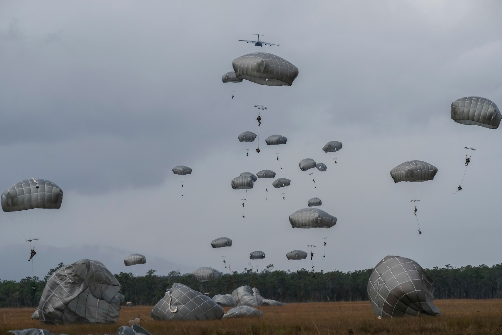 Paratroopers of 4th Infantry Brigade Combat Team (Airborne) 25th Infantry Division, Canadian Army, and U.S. Army Civil Affairs exit a C-17 Globemaster over Kapyong Dropzone in Shoalwater Bay, Queensland, Australia, July 13. The airborne operation was conduction as part of Exercise Talisman Sabre 2017, a massive, biennial exercise designed to exercise the partnership of joint forces throughout the Pacific region. (U.S. Army photo by Staff Sgt. Daniel Love)