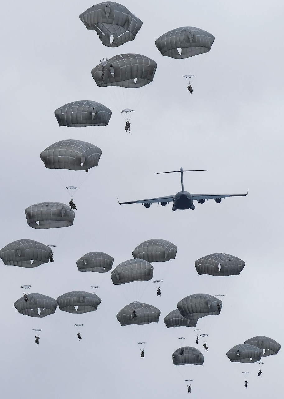 Paratroopers of 4th Infantry Brigade Combat Team (Airborne) 25th Infantry Division, Canadian Army, and U.S. Army Civil Affairs exit a C-17 Globemaster over Kapyong Dropzone in Shoalwater Bay, Queensland, Australia, July 13. The airborne operation was conducted as part of Exercise Talisman Sabre 2017, a massive, biennial exercise designed to exercise the partnership of joint forces throughout the Pacific region. (U.S. Army photo by Staff Sgt. Daniel Love)