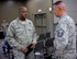 Commander of the 932nd Airlift Wing, Col. Esteban Ramirez, listens and speaks with Master Sgt. Matthew Hartweg from the command post shop following a security briefing class held July 9, 2017.  The information course covered the various levels of classification and how to handle them.  The 932nd AW is a 22nd Air Force unit located at Scott Air Force Base, Illinois.  (U.S. Air Force photo by Lt. Col. Stan Paregien)