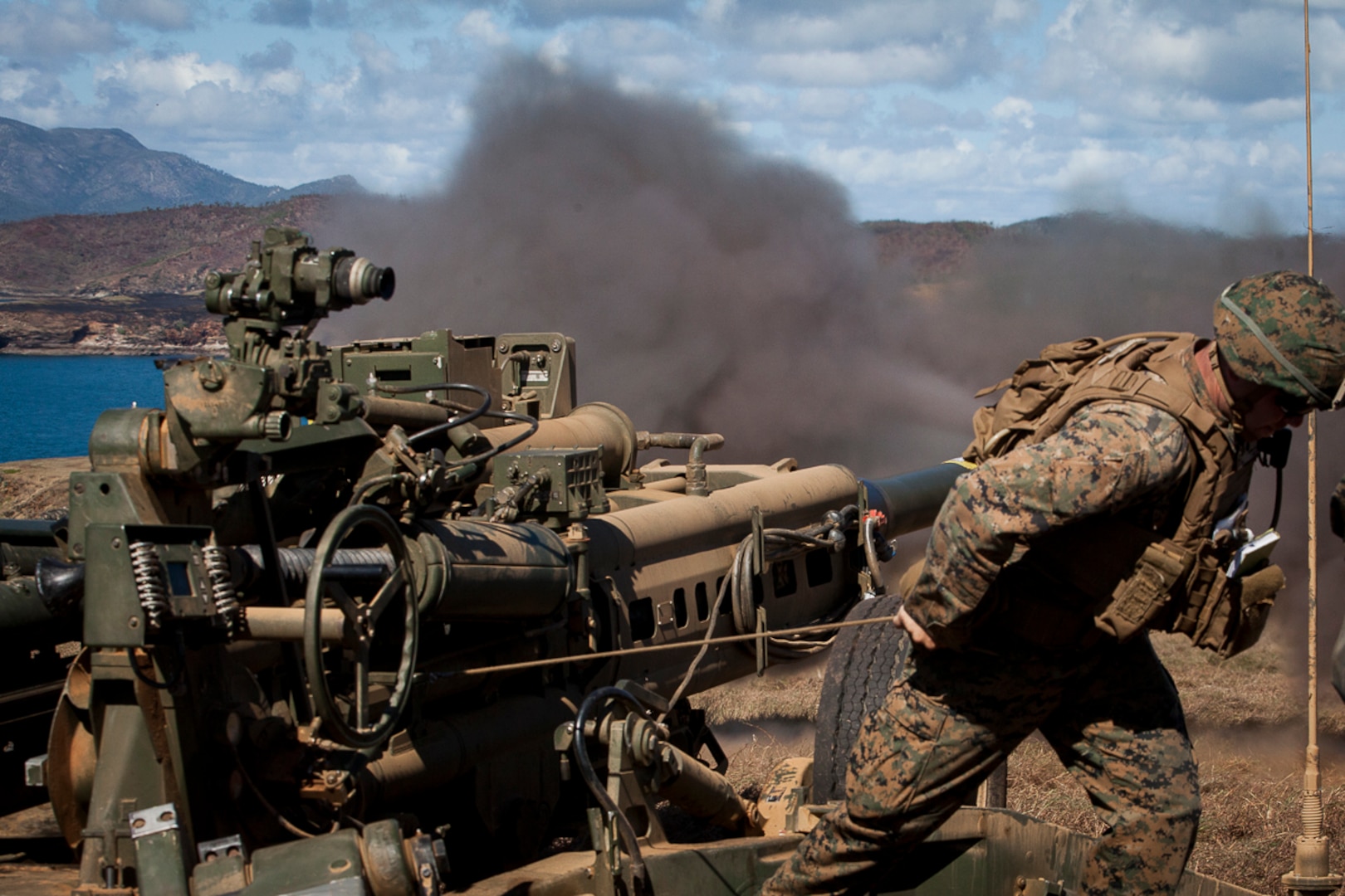 Sgt. William Fabrocini, a fire direction center chief with Weapons Company, Battalion Landing Team, 3rd Battalion, 5th Marines, pulls the lanyard on an M777A2 155 mm howitzer as part of direct-fire training during Exercise Talisman Saber 17 on Townshend Island, Shoalwater Bay Training Area, Queensland, Australia, July 17, 2017. Fabrocini, a native of Van Nuys, California, enlisted in 2009 after graduating from Van Nuys High School. BLT 3/5 is the Ground Combat Element for the 31st Marine Expeditionary Unit, and is exploring state-of-the-art concepts and technologies as the dedicated force for Sea Dragon 2025, a Marine Corps initiative to prepare for future battles. Talisman Saber is a biennial exercise designed to improve the interoperability between Australian and U.S. forces. The 31st MEU is taking part in Talisman Saber 17 while deployed on a regularly-scheduled patrol of the Indo-Asia-Pacific region. (U.S. Marine Corps photo by Lance Cpl. Stormy Mendez/Released)
