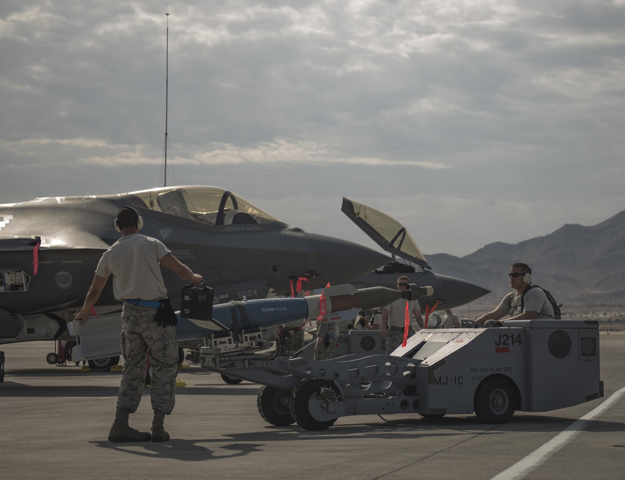 U.S. Air Force Staff Sgt. Jeremy Mckague, left, and Senior Airman Blake Baker, both 33rd Aircraft Maintenance Squadron weapons load crew members, prepare a GBU-12 to be loaded on an F-35A Lightning II July 18, at Nellis Air Force Base, Nev. The 33rd Fighter Wing and Marine Attack Squadron 221 from Yuma, Ariz., participated in the first combat exercise with Air Force F-35As and Marine Corps F-35Bs operating simultaneously during Red Flag 17-3. The large scale exercise, which was developed to provide pilots with critical experience in combat situations, enabled F-35 pilots to plan and train using the same tactics, techniques and procedures. (U.S. Air Force photo by Staff Sgt. Peter Thompson)