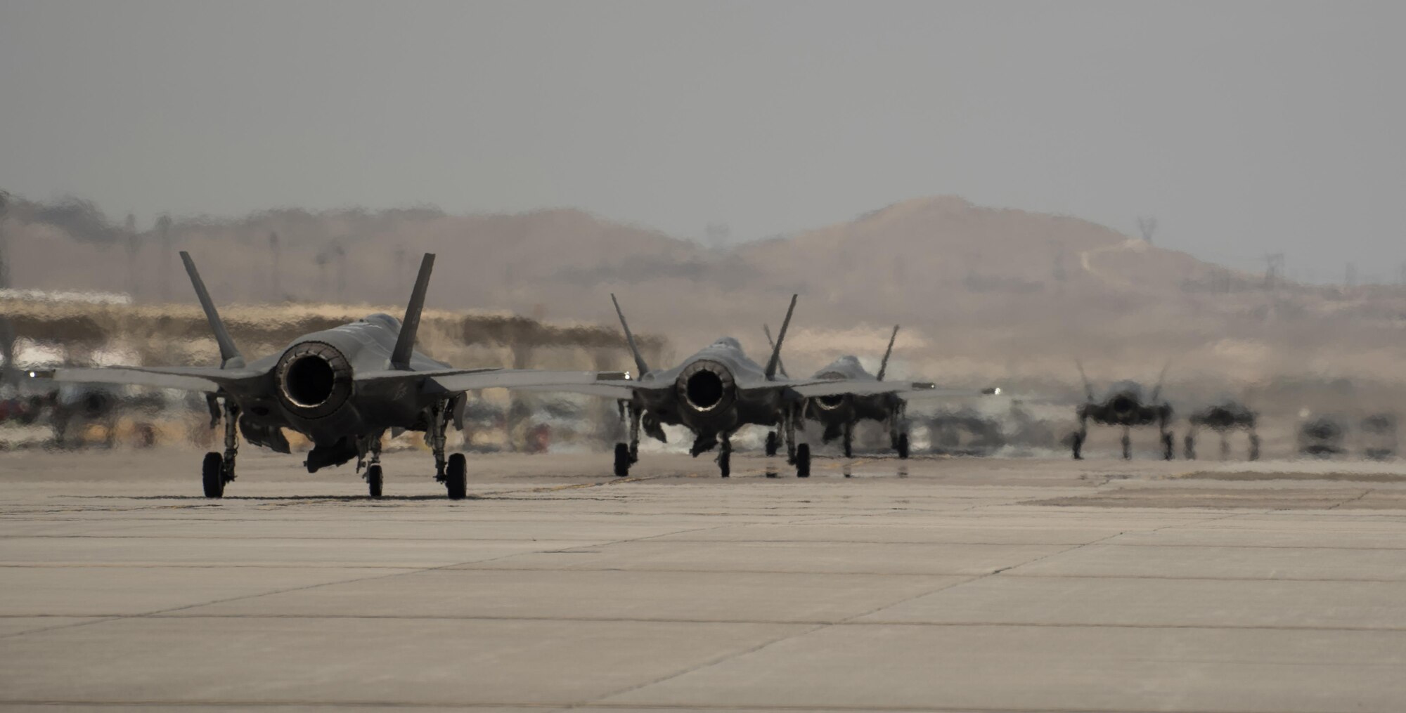 U.S. Air Force F-35A and Marine Corps F-35B Lightning IIs taxi before taking off July 18, 2017, at Nellis Air Force Base, Nev. The 33rd Fighter Wing and Marine Attack Squadron 221 from Yuma, Ariz., participated in the first combat exercise with Air Force F-35As and Marine Corps F-35Bs operating simultaneously during Red Flag 17-3. The large scale exercise, which was developed to provide pilots with critical experience in combat situations, enabled F-35 pilots to plan and train using the same tactics, techniques and procedures. (U.S. Air Force photo by Staff Sgt. Peter Thompson)