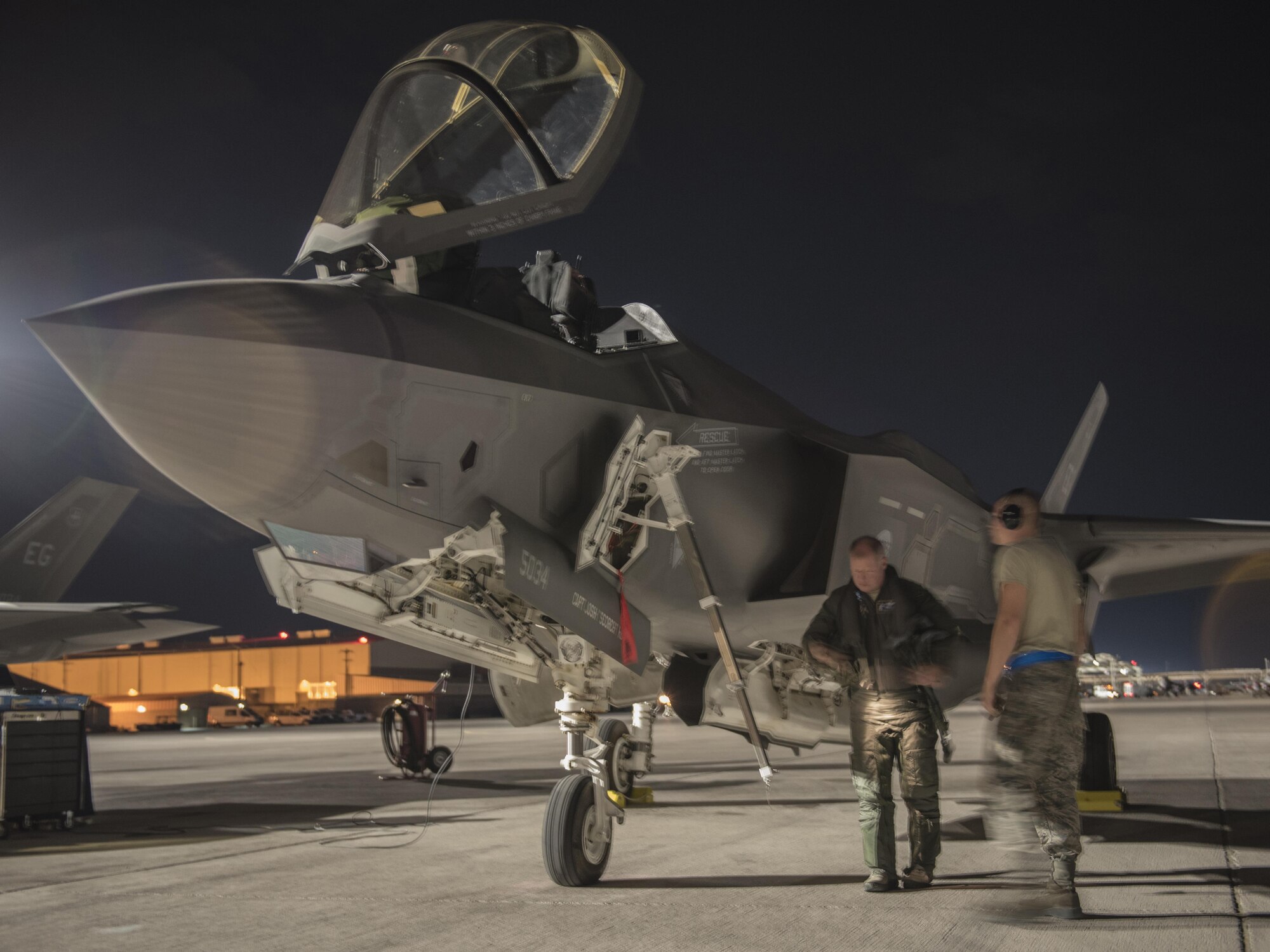 U.S. Air Force Reserve Lt. Col. Brett Robison, F-35 Lightning II Academic Training Center lead pilot, inspects an F-35A Lightning II July 18, 2017, at Nellis Air Force Base, Nev. The 33rd Fighter Wing and Marine Attack Squadron 221 from Yuma, Ariz., participated in the first combat exercise with Air Force F-35As and Marine Corps F-35Bs operating simultaneously during Red Flag 17-3. The large scale exercise, which was developed to provide pilots with critical experience in combat situations, enabled F-35 pilots to plan and train using the same tactics, techniques and procedures. (U.S. Air Force photo by Staff Sgt. Peter Thompson)