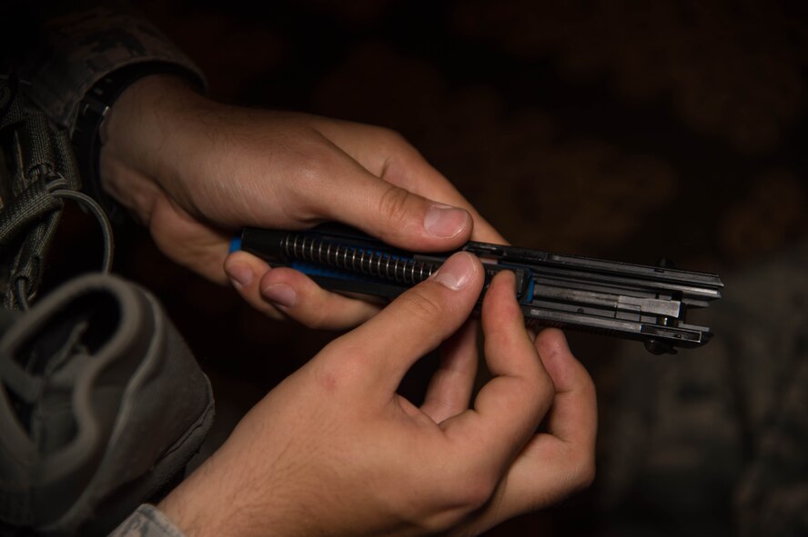 A defender with the 307th Security Forces Squadron changes the barrel of a 9mm handgun in the preparation of an active shooter exercise at Barksdale Air Force Base, La., May 31, 2017. The simulated rounds provided defenders with near to real-life situations, testing the reaction and response toward hostile and non-hostile targets. (U.S. Air Force photo by Staff Sgt. Jason McCasland)
