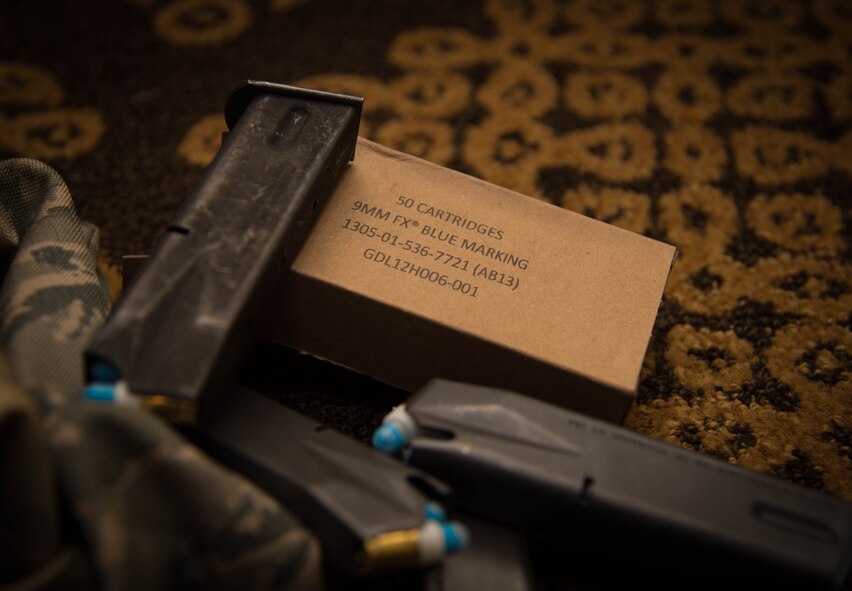Pistol magazines loaded with Loaded trainer 9mm paint rounds are stacked during an active shooter training exercise at Barksdale Air Force Base, La., May 31, 2017. The simulated rounds were loaded with paint rounds in place of a regular 9mm round when fired, the round disintegrates on contact, turning into paint and marking targets providing realism to the training. (U.S. Air Force photo by Staff Sgt. Jason McCasland)