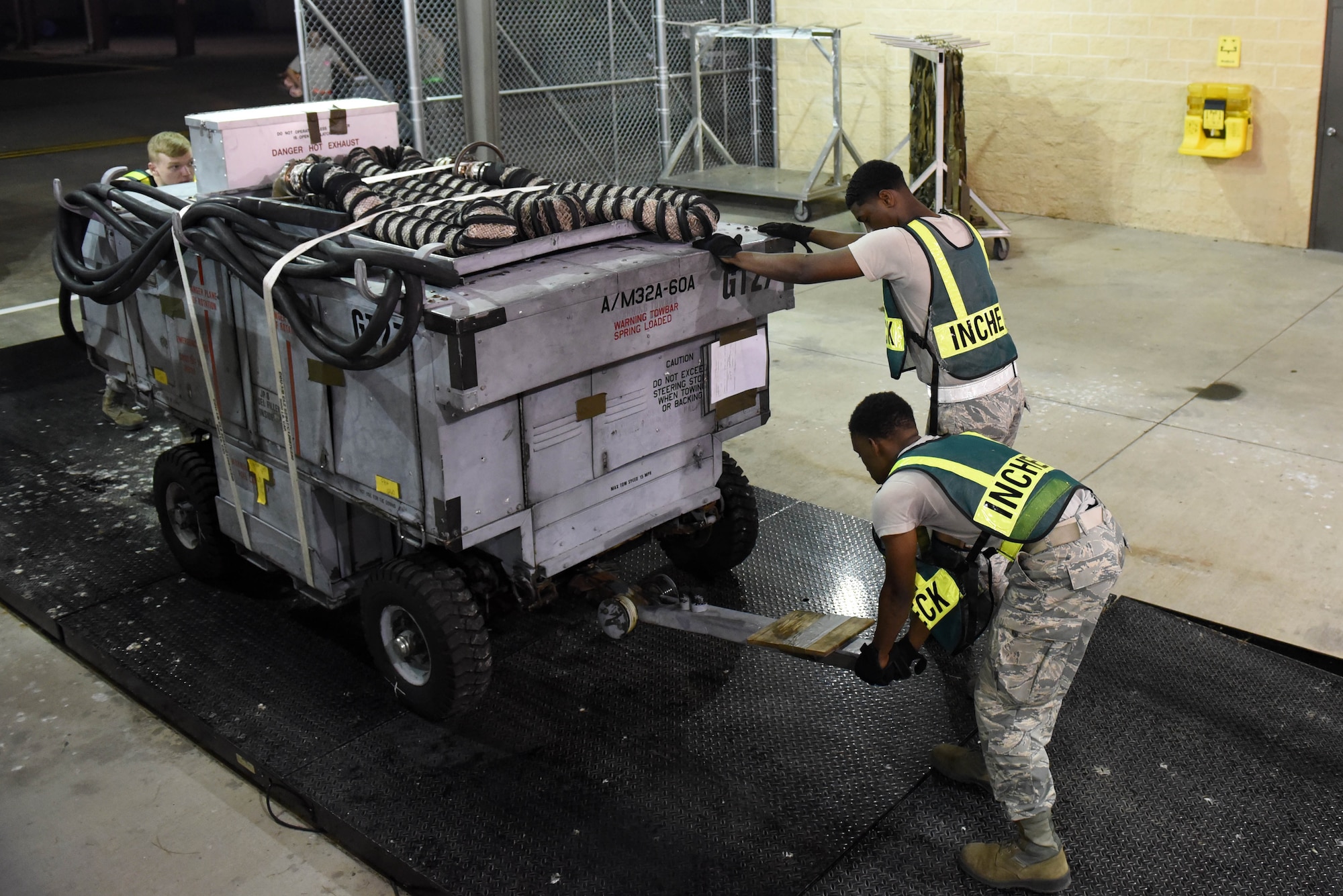Members of the 4th Mission Support Group remove a generator cart from a weighing scale during exercise Thunderdome 17-02, July 20, 2017, at Seymour Johnson Air Force Base, North Carolina. The exercise allowed members of the 4th Fighter Wing to strengthen skills for real-world operations. (U.S. Air Force photo by Airman 1st Class Victoria Boyton)