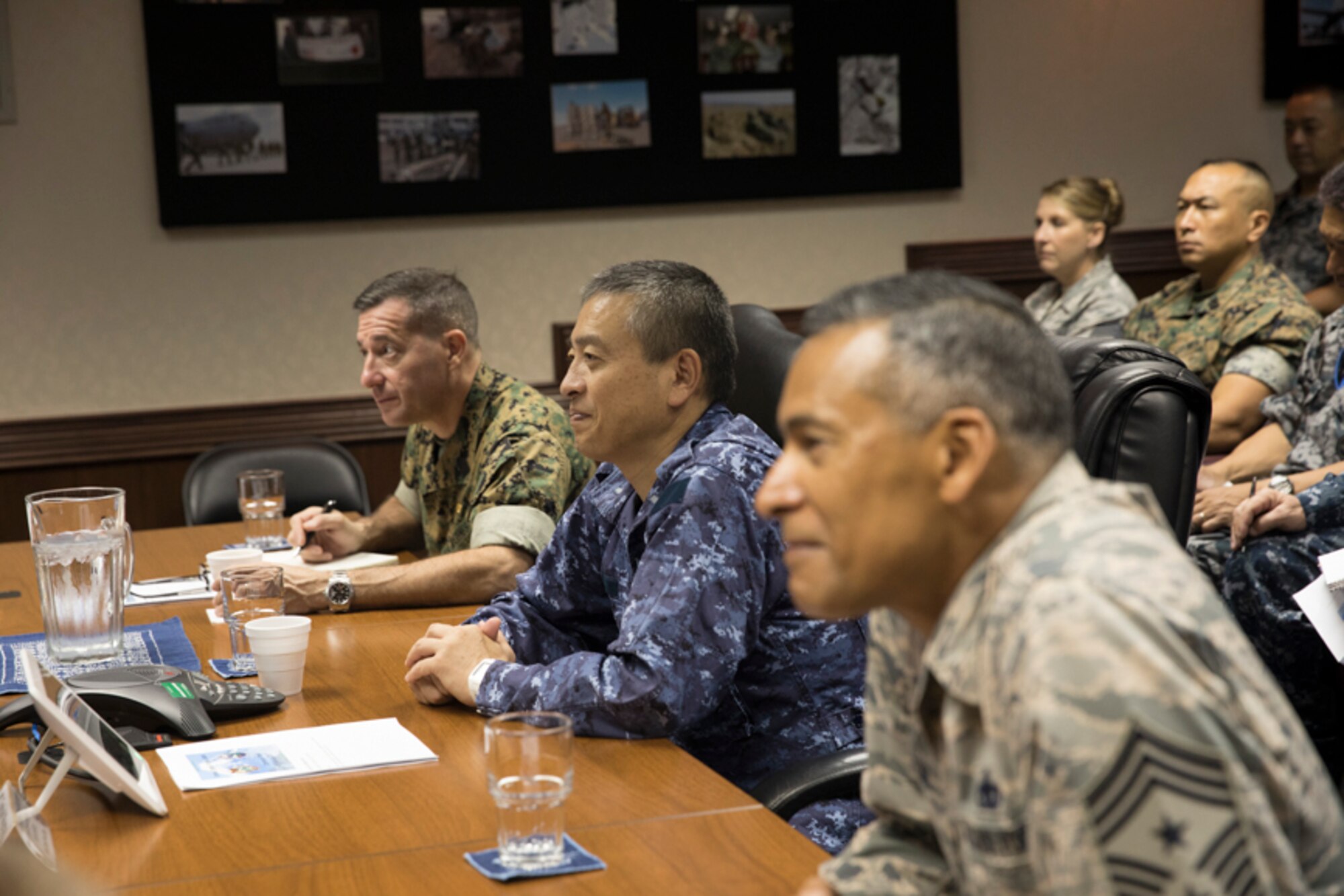 U.S. Air Force Chief Master Sgt. Terrence Greene, United States Forces, Japan and 5th Air Force command chief, Japan Maritime Self-Defense Force Warrant Officer Toshiaki Miyamae, Joint Staff senior enlisted adviser to the chief of staff, and U.S. Marine Corps Sgt. Maj. Anthony Spadaro, U.S. Pacific Command senior enlisted leader, listen to opening remarks during the bilateral Senior Enlisted Leader (SEL) Symposium at Yokota Air Base, Japan, July 13, 2017. The symposium was a two-day event in which SELs between U.S. and Japan discuss various enlisted leadership development programs. (U.S. Air Force photo by Yasuo Osakabe)