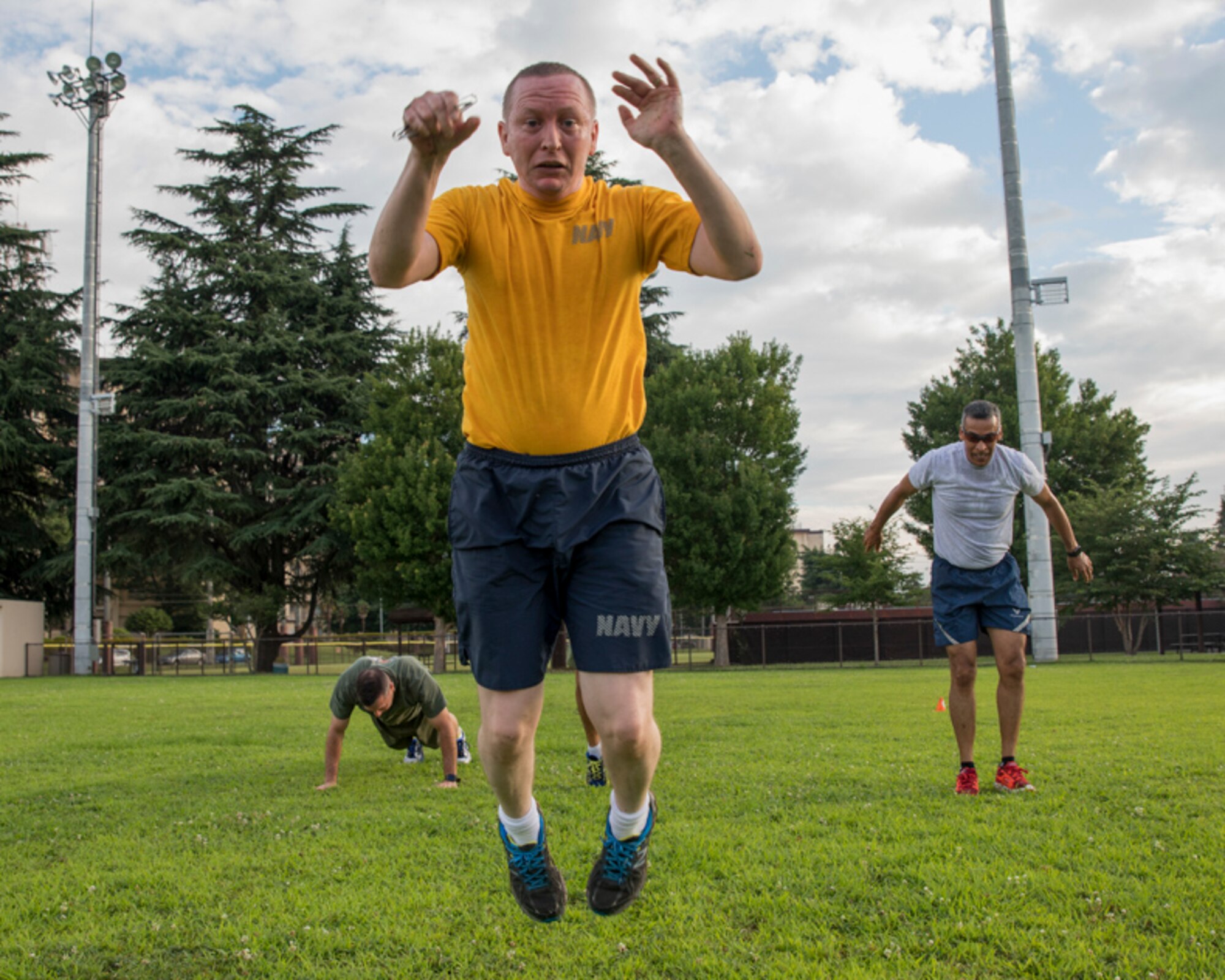 U.S. Navy Chief Petty Officer Charles Tindle, United States Forces, Japan navy and marine corps personnel manager, performs burpee exercise during the bilateral Senior Enlisted Leader Symposium physical training session at Yokota Air Base, Japan, July 19, 2017. The burpee, also known as squat thrusts, are one of the few equipment-free exercises that works the entire body and gives a cardiovascular workout. (U.S. Air Force photo by Yasuo Osakabe)