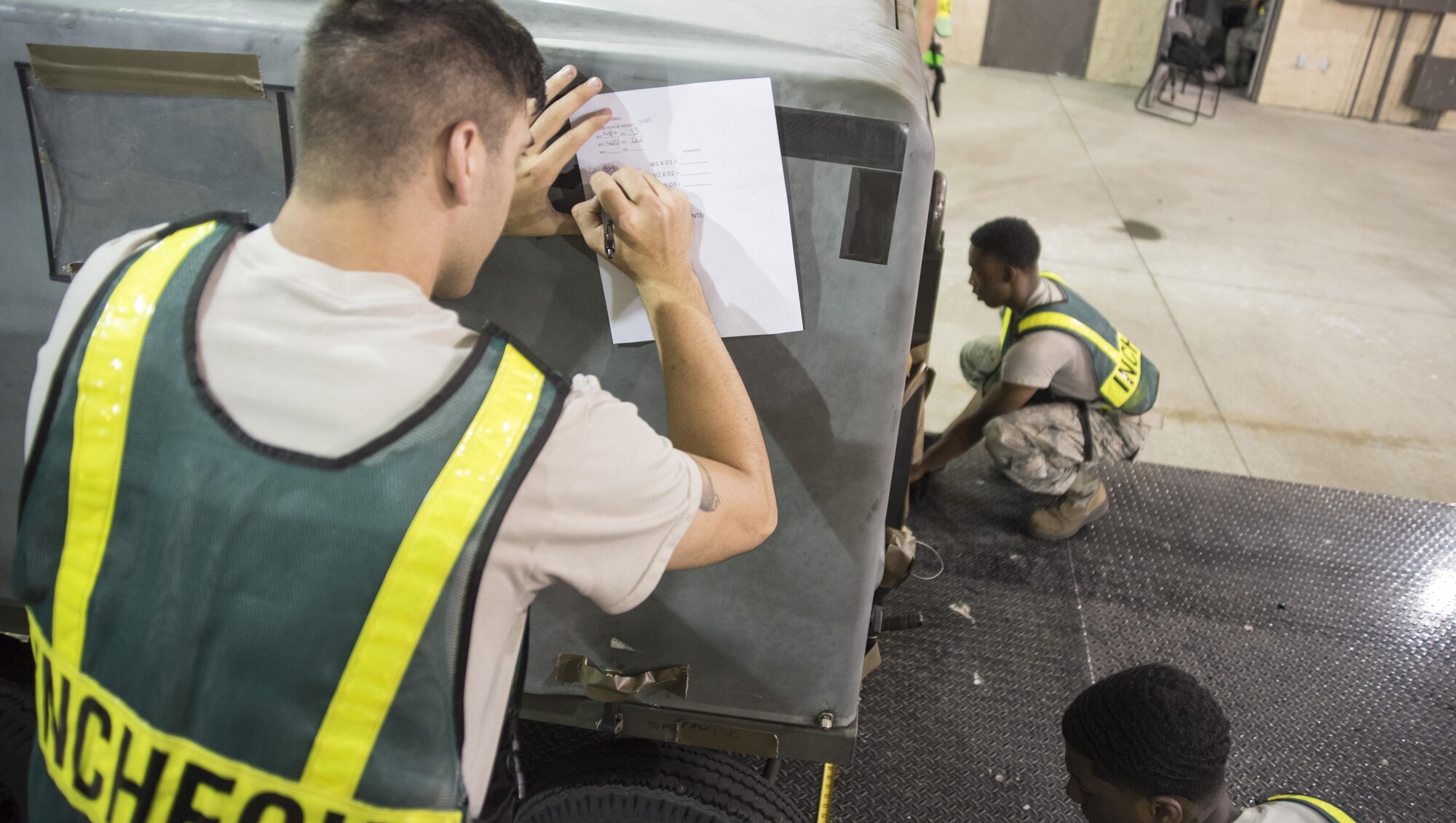 Members of the 4th Logistics Readiness Squadron travel management office determine the weight and dimensions of a nitrogen cart July 20, 2017, at Seymour Johnson Air Force Base, North Carolina. This process was a part of exercise Thunderdome 17-02, which is designed to evaluate the 4th Fighter Wing’s ability to generate and deploy aircraft, Airmen and equipment. (U.S. Air Force photo by Tech. Sgt. David W. Carbajal)