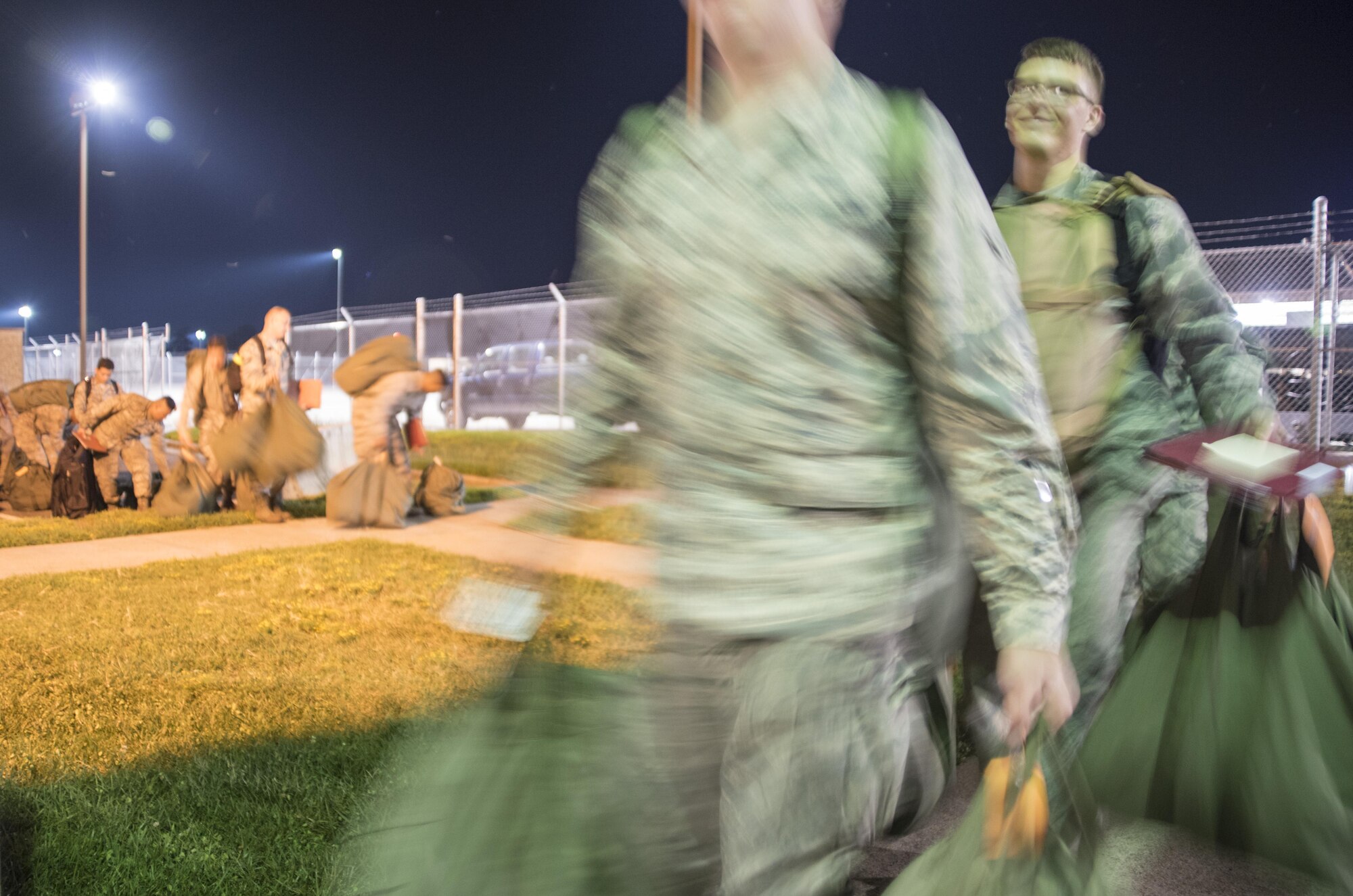 Airmen carry their deployment bags into the pre-deployment function processing center July 20, 2017, at Seymour Johnson Air Force Base, North Carolina. The processing line was a part of exercise Thunderdome 17-02, which is designed to evaluate the 4th Fighter Wing’s ability to generate and deploy aircraft, Airmen and equipment. (U.S. Air Force photo by Tech. Sgt. David W. Carbajal)