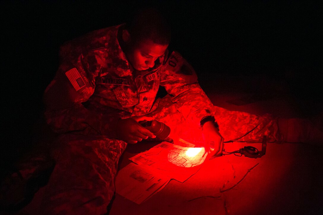 Army Sgt. Luther Witherspoon determines the grid coordinate of a point on a map during night land navigation at Camp Atterbury, Ind., July 18, 2017, during Army Materiel Command's Best Warrior Competition. Witherspoon is assigned to the Army Sustainment Command. Soldiers were tested on basic and advanced warrior tasks and drills during the three-day competition. Army photo by Sgt. 1st Class Teddy Wade