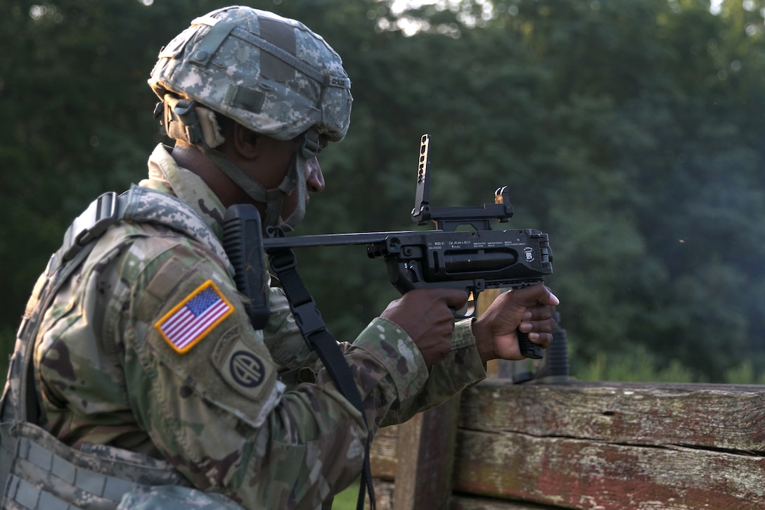 Army Sgt. 1st Class Joaquin Spikes fires a 40mm training grenade from an M320 grenade launcher module at Camp Atterbury, Ind., July 18, 2017, during Army Materiel Command's Best Warrior Competition. Spikes is assigned to the U.S. Army Security Assistance Command. Army photo by Sgt. 1st Class Teddy Wade
