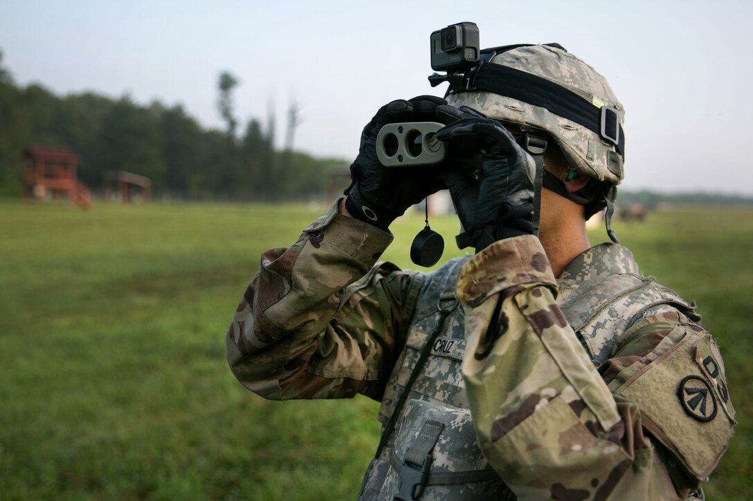 Army Sgt. Luis Cruz utilizes a laser range finder to determine the distance of a target at a grenade launcher range at Camp Atterbury, Ind., July 18, 2017, during Army Materiel Command's Best Warrior Competition. Cruz is assigned to the 687th Rapid Port Opening Element. Army photo by Sgt. 1st Class Teddy Wade