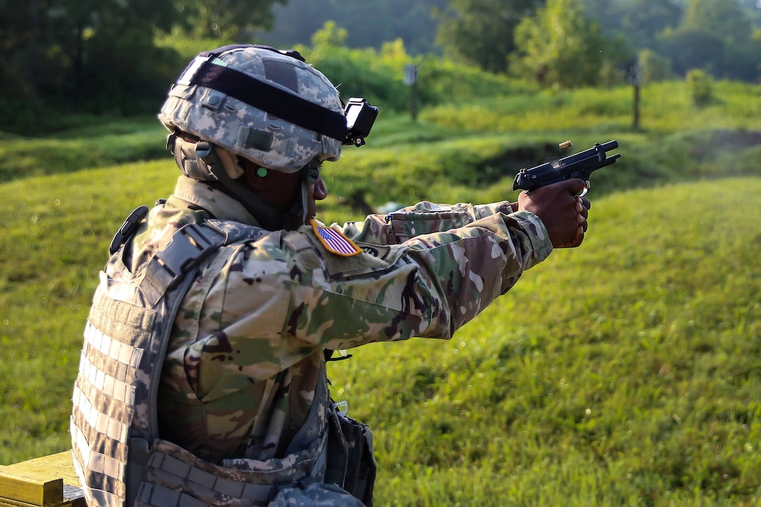Army Sgt. 1st Class Joaquin Spikes fires an M9 pistol during competition at Camp Atterbury, Ind., July 18, 2017, during Army Materiel Command's Best Warrior Competition. Spikes is assigned to the U.S. Army Security Assistance Command. Army photo by Sgt. 1st Class Teddy Wade