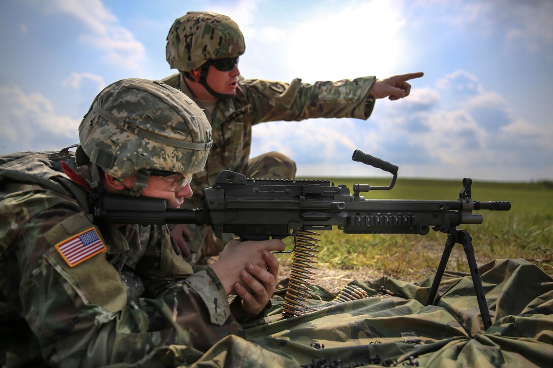 Army Pfc. Robert Nelson fires an M249 light machine gun during a weapons qualification range at Camp Atterbury, Ind., July 18, 2017, during Army Materiel Command's Best Warrior Competition. Nelson is assigned to the 687th Rapid Port Opening Element. Army photo by Sgt. 1st Class Teddy Wade