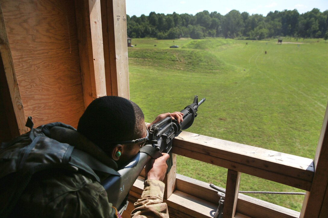 Army Staff Sgt. Qujuan Baptiste fires at multiple targets from an open window during a stress shoot scenario at Camp Atterbury, Ind., July 18, 2017, during Army Materiel Command's Best Warrior Competition. Baptiste is assigned to the Army Sustainment Command. Army photo by Sgt. 1st Class Teddy Wade