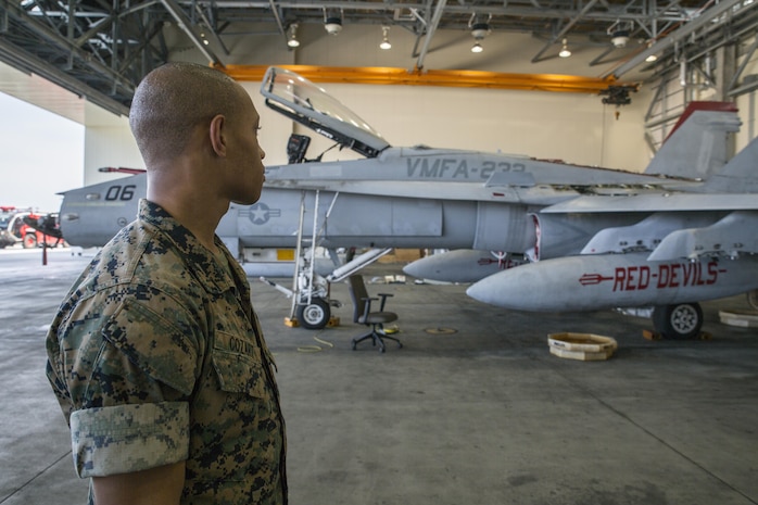 U.S. Marine Corps Pfc. Christian Cozart, an aircraft rescue firefighter with Headquarters and Headquarters Squadron, visits a display of an F/A-18C Hornet at Marine Corps Air Station Iwakuni, Japan, July 19, 2017. Aircraft Rescue and Firefighting Marines visited the display to familiarize themselves with the aircraft so they can be more effective in emergency situations. (U.S. Marine Corps Lance Cpl. Gabriela Garcia-Herrera)