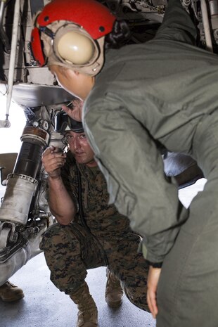 U.S. Marine Corps Staff Sgt. Jeremiah Welling, left, a quality assurance specialist with Marine Fighter Attack Squadron (VMFA) 232, teaches Lance Cpl. Dahee Park, right, an aircraft rescue firefighter with Headquarters and Headquarters Squadron, about the inside of an F/A-18C Hornet at Marine Corps Air Station Iwakuni, Japan, July 19, 2017. Aircraft Rescue and Firefighting Marines visited the aircraft display to familiarize themselves with the aircraft, so they can be more effective in emergency situations. (U.S. Marine Corps Lance Cpl. Gabriela Garcia-Herrera)