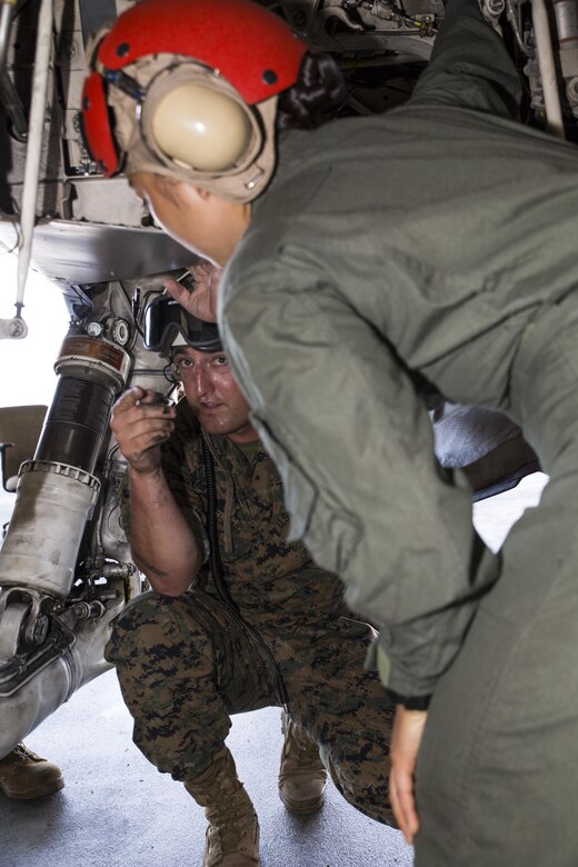 U.S. Marine Corps Staff Sgt. Jeremiah Welling, left, a quality assurance specialist with Marine Fighter Attack Squadron (VMFA) 232, teaches Lance Cpl. Dahee Park, right, an aircraft rescue firefighter with Headquarters and Headquarters Squadron, about the inside of an F/A-18C Hornet at Marine Corps Air Station Iwakuni, Japan, July 19, 2017. Aircraft Rescue and Firefighting Marines visited the aircraft display to familiarize themselves with the aircraft, so they can be more effective in emergency situations. (U.S. Marine Corps Lance Cpl. Gabriela Garcia-Herrera)