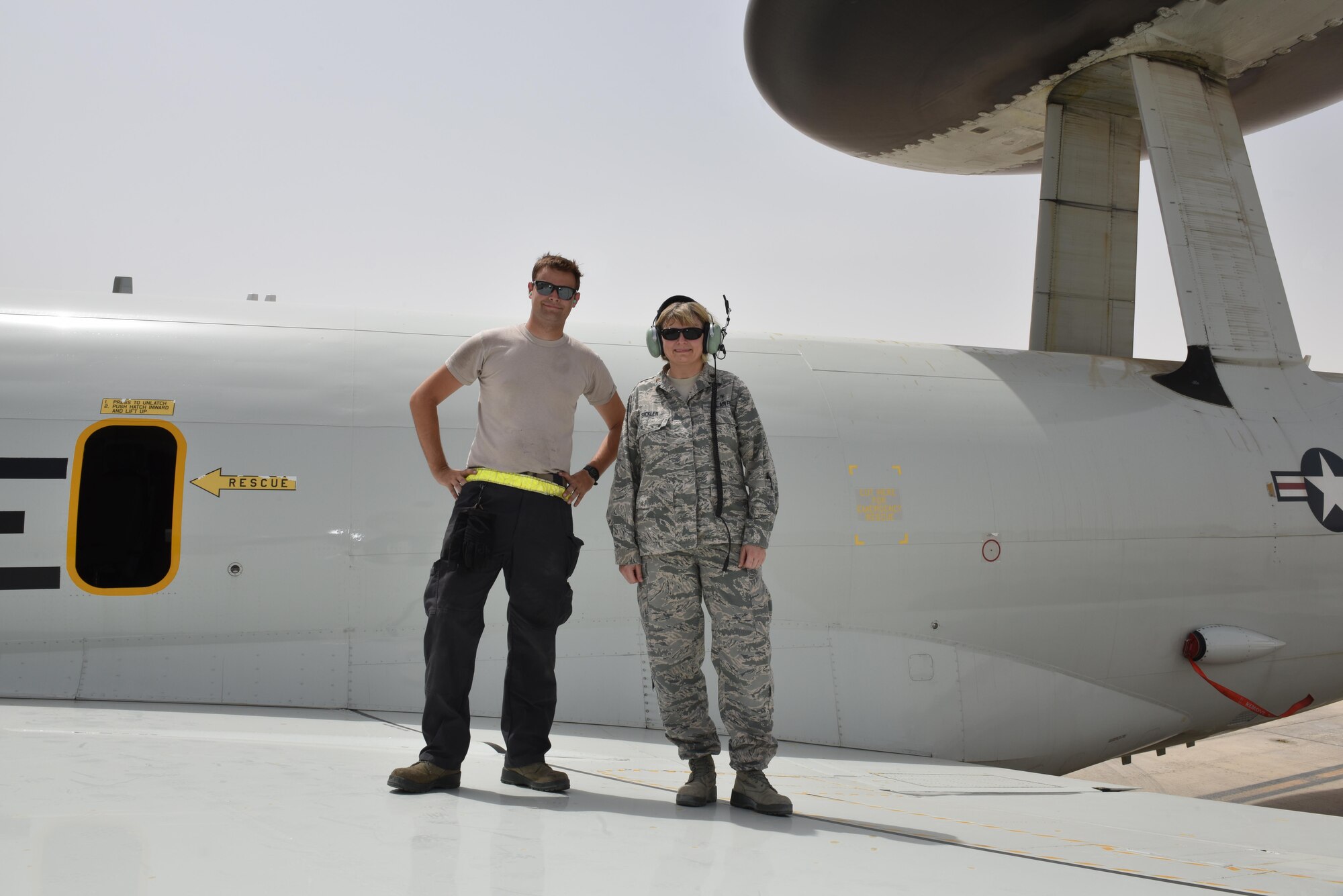 Senior Airman Colt, left, and his mother Maj. Donna, right, stand on the wing of an E-3 Sentry at Al Dhafra Air Base, United Arab Emirates, July 20, 2017. Donna, currently deployed to Al Udeid Air Base, Qatar, coordinated with U.S. Air Forces Central Command and 380th Air Expeditionary Wing leadership to surprise her son. (U.S. Air Force photo by Staff Sgt. Marjorie A. Bowlden)