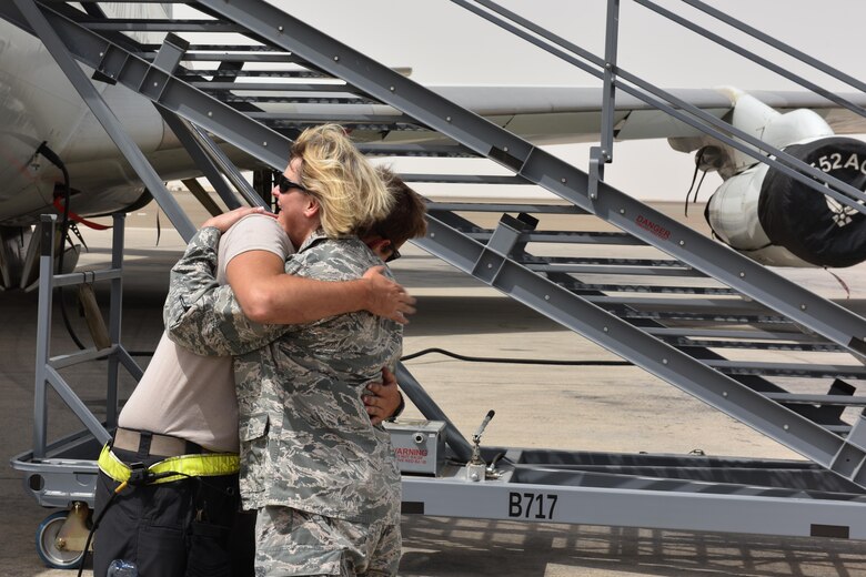 Maj. Donna, U.S. Air Forces Central Command sexual assault response coordinator, and her son Senior Airman Colt embrace at Al Dhafra Air Base, United Arab Emirates, July 20, 2017. Donna and Colt reunited while deployed after spending approximately two years apart. (U.S. Air Force photo by Staff Sgt. Marjorie A. Bowlden)
