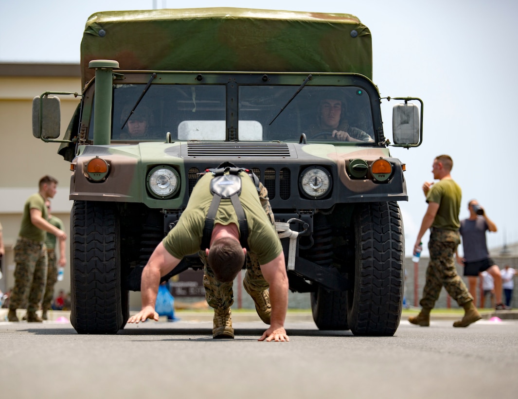 U.S. Marines with Marine Aviation Logistics Squadron 12 pull a Humvee at Marine Corps Air Station Iwakuni, Japan, July 21, 2017. The USO hosted a field meet and cookout for MALS-12, which included several competitions such as grappling, pull-ups and a Humvee pull. 