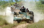 An M113 Armored Personnel Carrier of Company D, 1st Battalion, 148th Infantry, 37th Brigade, 38th Infantry Division moves into position during a platoon live-fire exercise at Camp Grayling Mich., July 2005.