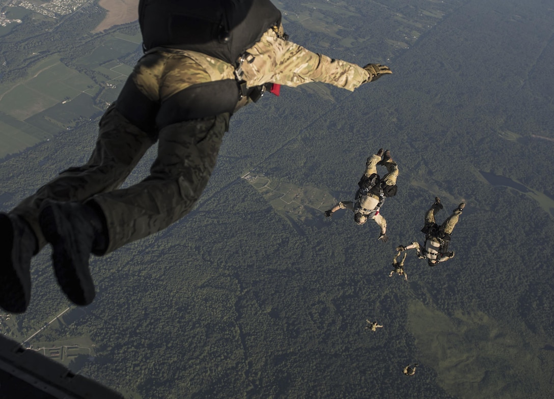 Special Tactics Airmen with the 123rd Special Tactics Squadron, Louisville, Ky., execute a high altitude, low open jump out of a 15th Special Operations Squadron MC-130H Combat Talon II, during a total force exercise mission over Terra Haute, Ind., July 8, 2017. Air Commandos with the 1st Special Operations Wing conduct exercises with joint services to strengthen the development of joint leaders and teams to better understand the synergy of air, space and cyber power, and how to synthesize the capabilities the air component brings with the other elements of joint and national power. (U.S. Air Force photo/Tech. Sgt. Jeffrey Curtin)