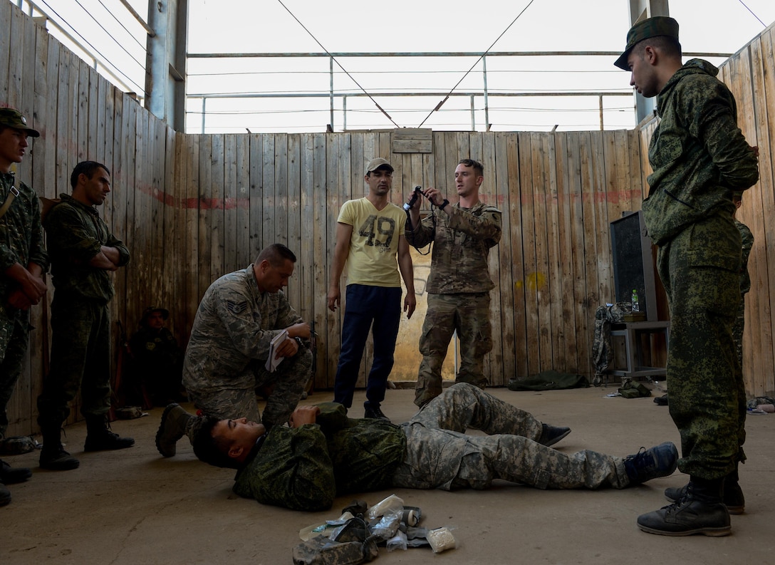A Soldier from the 183rd Regiment, 1st Battalion, Virginia National Guard instructs  Tajik service members about self-aid buddy care procedures during a field training exercise part of multinational exercise Regional Cooperation 2017, July 17, 2017, in Fakhrabad, Tajikistan. Hosted by Tajikistan's Ministry of Defense, RC 17 affords participants the opportunity to exercise a United Nations directive to focus counterterrorism, border security and peacekeeping operations. During RC 17, service members from U.S. Central Command will train alongside the armed forces of Kyrgyzstan, Tajikistan, the Islamic Republic of Pakistan, Mongolia and observers from Kazakhstan. (U.S. Air Force photo by Staff Sgt. Michael Battles)