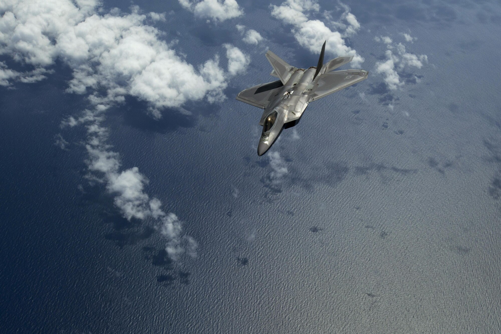 A F-22 Raptor assigned to Joint Base Langley-Eustis, Va., banks away after being refueled by a KC-10 Extender crewed by members of the 78th Air Refueling Squadron, 514th Air Mobility Wing, flies over the Atlantic Ocean July 15, 2017. The F-22 is assigned to Joint Base Langley-Eustis, Va., and is the Air Force’s 5th generation fighter aircraft. The KC-10 is an Air Mobility Command advanced tanker and cargo aircraft designed to provide increased global mobility for U.S. Armed Forces and is assigned to the 305th Air Mobility Wing and is maintained and flown by the 514th Air Mobility Wing, Air Force Reserve Command and the 305th. Both units are located at Joint Base McGuire-Dix-Lakehurst, N.J. (U.S. Air Force photo by Master Sgt. Mark C. Olsen/Released)