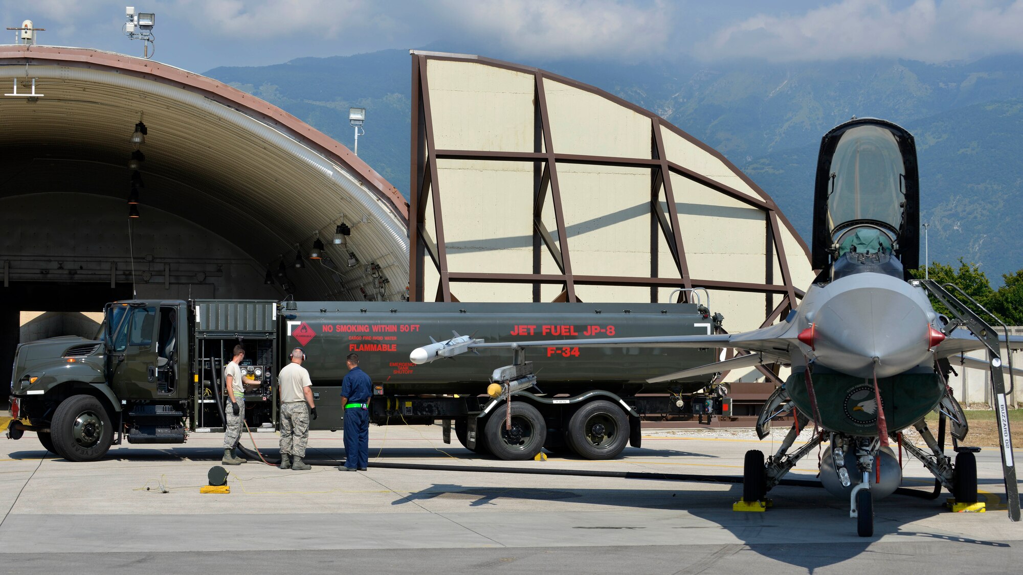 The 31st Logistics Readiness Squadron and 512th LRS, Dover Air Force Base, Delaware, Petroleum, Oil and Lubricants Airmen coordinate with a 31st Aircraft Maintenance Squadron crew chief to refuel an F-16 Fighting Falcon, July 19, 2017, at Aviano Air Base, Italy. The POL Airmen transferred approximately 1,000 gallons of fuel to keep the F-16 mission ready. (U.S. Air Force photo by Senior Airman Cary Smith)