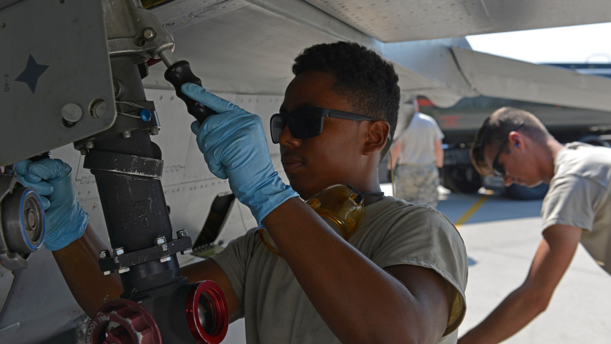 Airman Deric Quiroz, 31st Aircraft Maintenance Squadron crew chief, attaches a fuel hose to an F-16 Fighting Falcon, July 19, 2017, at Aviano Air Base, Italy. Airmen from the 31st Logistics Readiness Squadron joined forces with Air Force reservists assigned to the 512th LRS, Dover Air Force Base, Delaware, to refuel F-16s to keep them mission ready. (U.S. Air Force photo by Senior Airman Cary Smith)