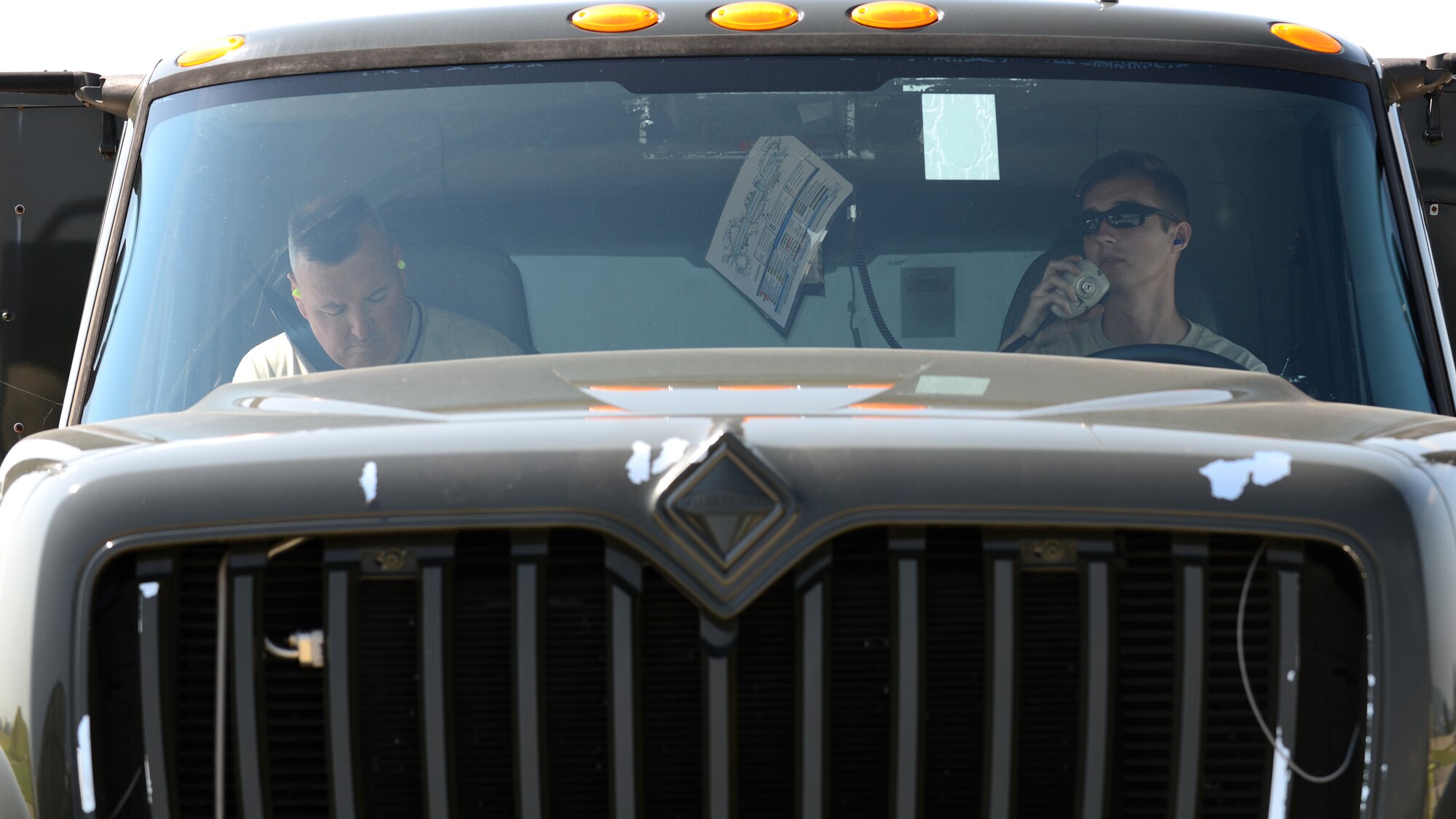 Senior Airman Matthew Ronan, 512th Logistics Readiness Squadron Petroleum Oil and Lubricants distribution operator, Dover Air Force Base, Delaware, and Airman 1st Class Aaron Sewell, 31st LRS POL distribution operator, coordinate the next aircraft refueling job, July 19, 2017, at Aviano Air Base, Italy. Air Force reservists assigned to the 512th LRS, Dover AFB, Delaware, joined the 31st LRS for two weeks of distance training at Aviano. (U.S. Air Force photo by Senior Airman Cary Smith)