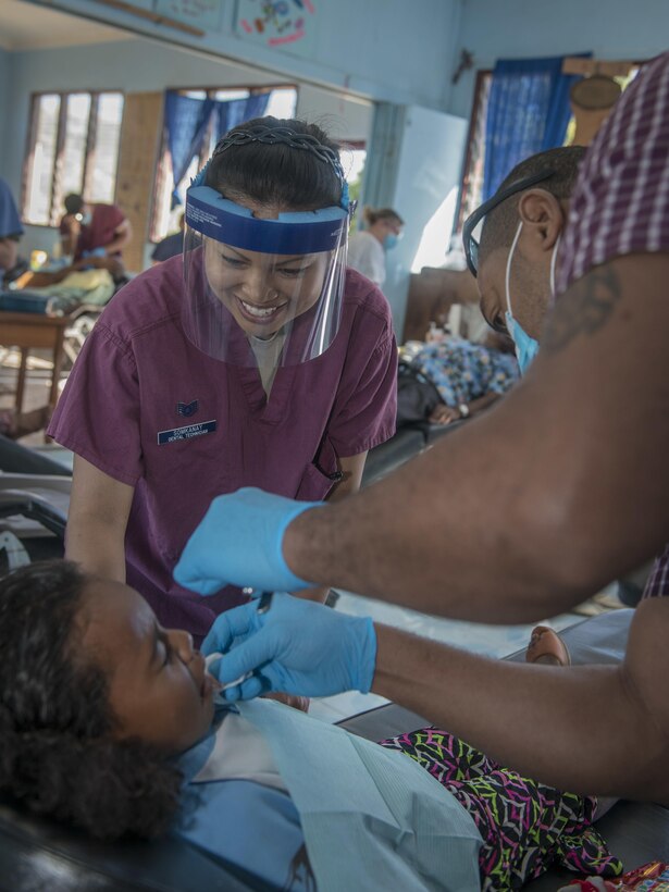 U.S. Air Force Staff Sgt. Tanatchaya Somkanay Purath, left, a dental technician with the 679th Dental Squadron at Joint Base Elmendorf-Richardson, Alaska, assists her Fijian dentist as they asses a patient’s dental needs during Pacific Angel (PACANGEL) 17-3 at Tagitagi Sangam School and Kindergarten in Tavua, Fiji, July 17, 2017. PACANGEL 17-3 builds partnerships between the U.S., Fiji, and five regional nations including Australia, Vanuatu, Indonesia, the Philippines and France by conducting multilateral humanitarian assistance and civil military operations, promoting regional military-civilian-nongovernmental organization cooperation and interoperability. (U.S. Air Force photo/Tech. Sgt. Benjamin W. Stratton)